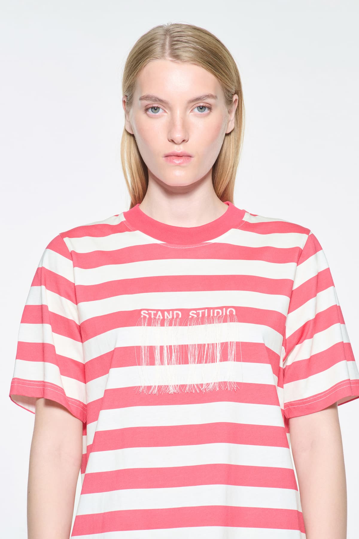 Close-up view of the Hallie T-Shirt in Watermelon Stripe/Fringe, Hallie Tee is a relaxed-fit striped t-shirt made from lightweight jersey fabric. The color is a red and white striped fabric.