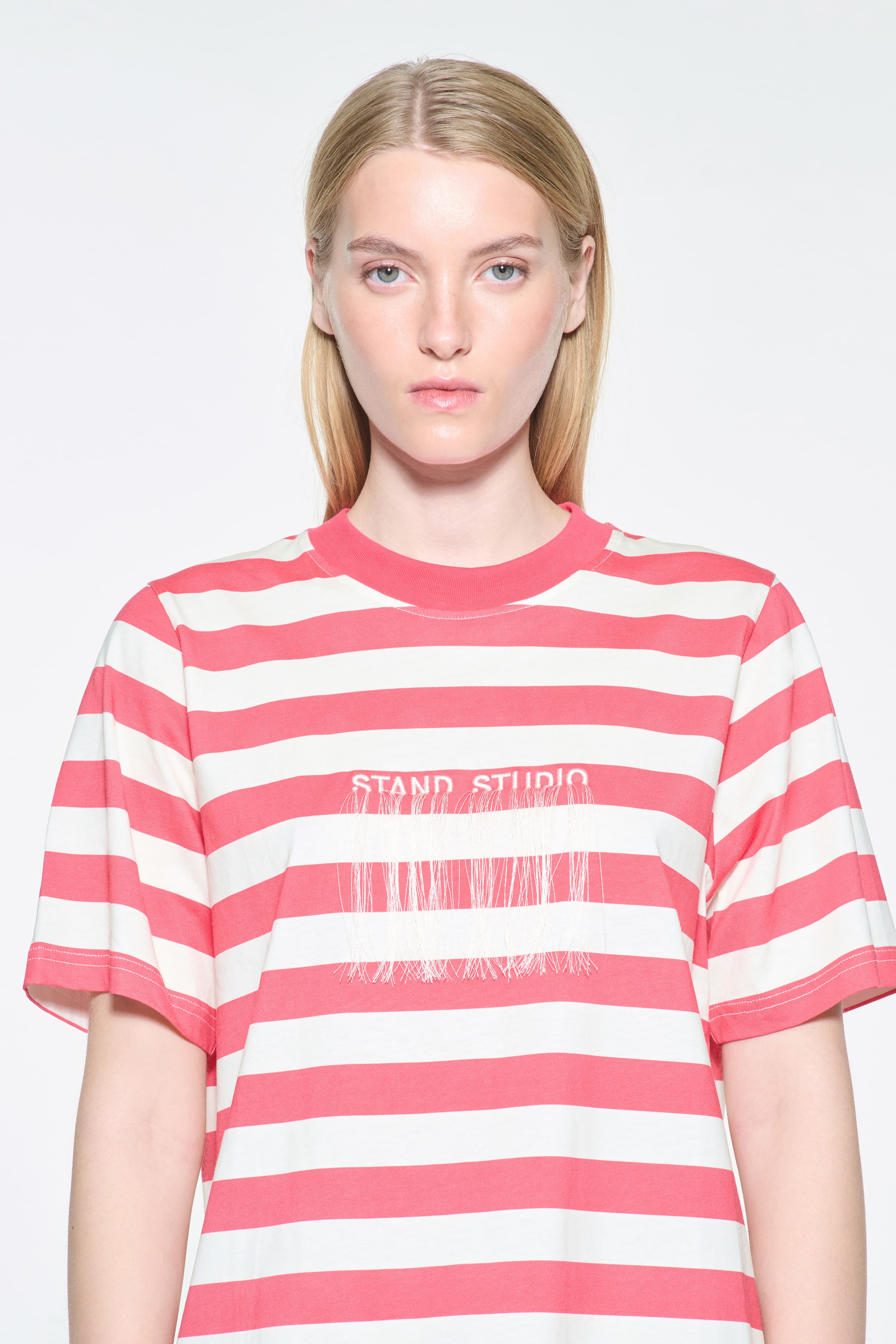 Close-up view of the Hallie T-Shirt in Watermelon Stripe/Fringe, Hallie Tee is a relaxed-fit striped t-shirt made from lightweight jersey fabric. The color is a red and white striped fabric.