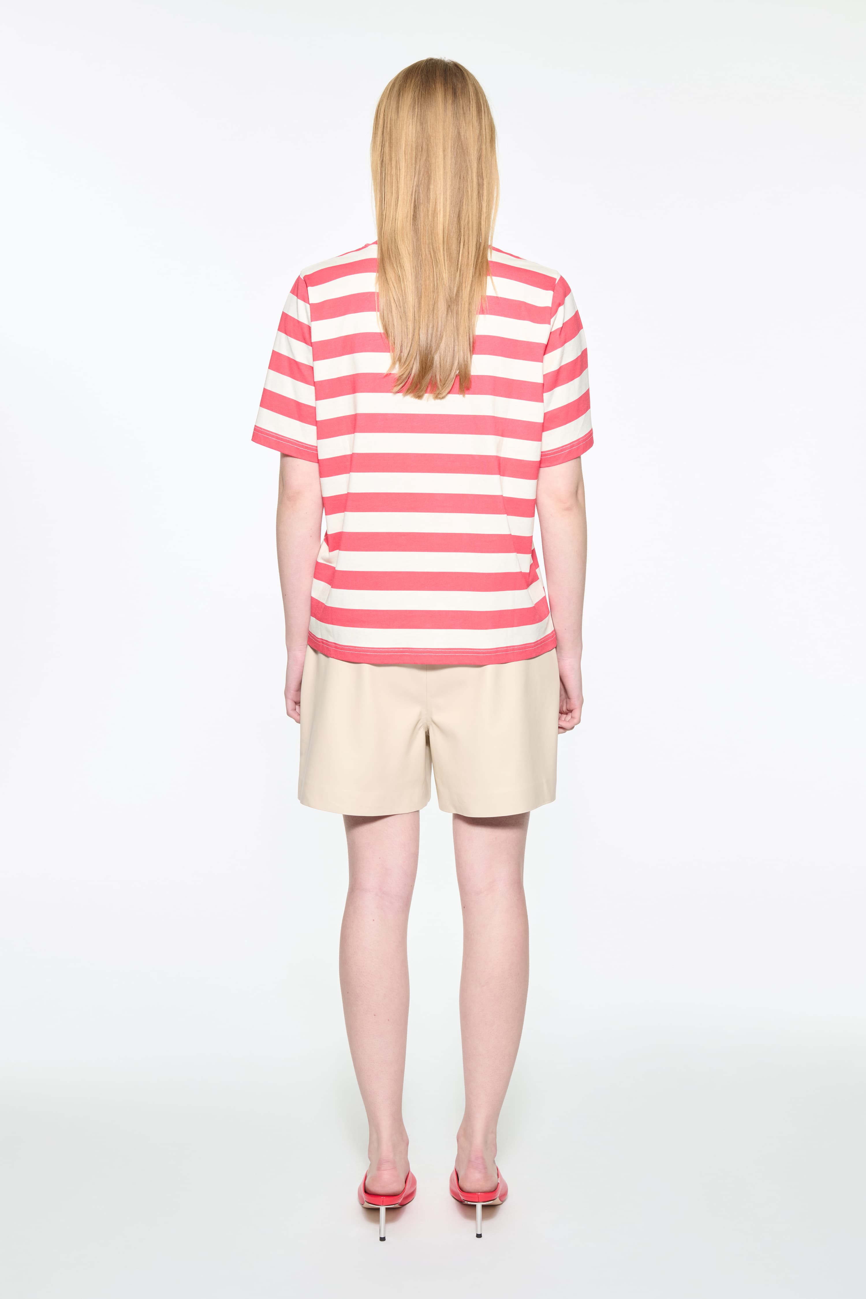 Back view of the Hallie T-Shirt in Watermelon Stripe/Fringe, Hallie Tee is a relaxed-fit striped t-shirt made from lightweight jersey fabric. The color is a red and white striped fabric.