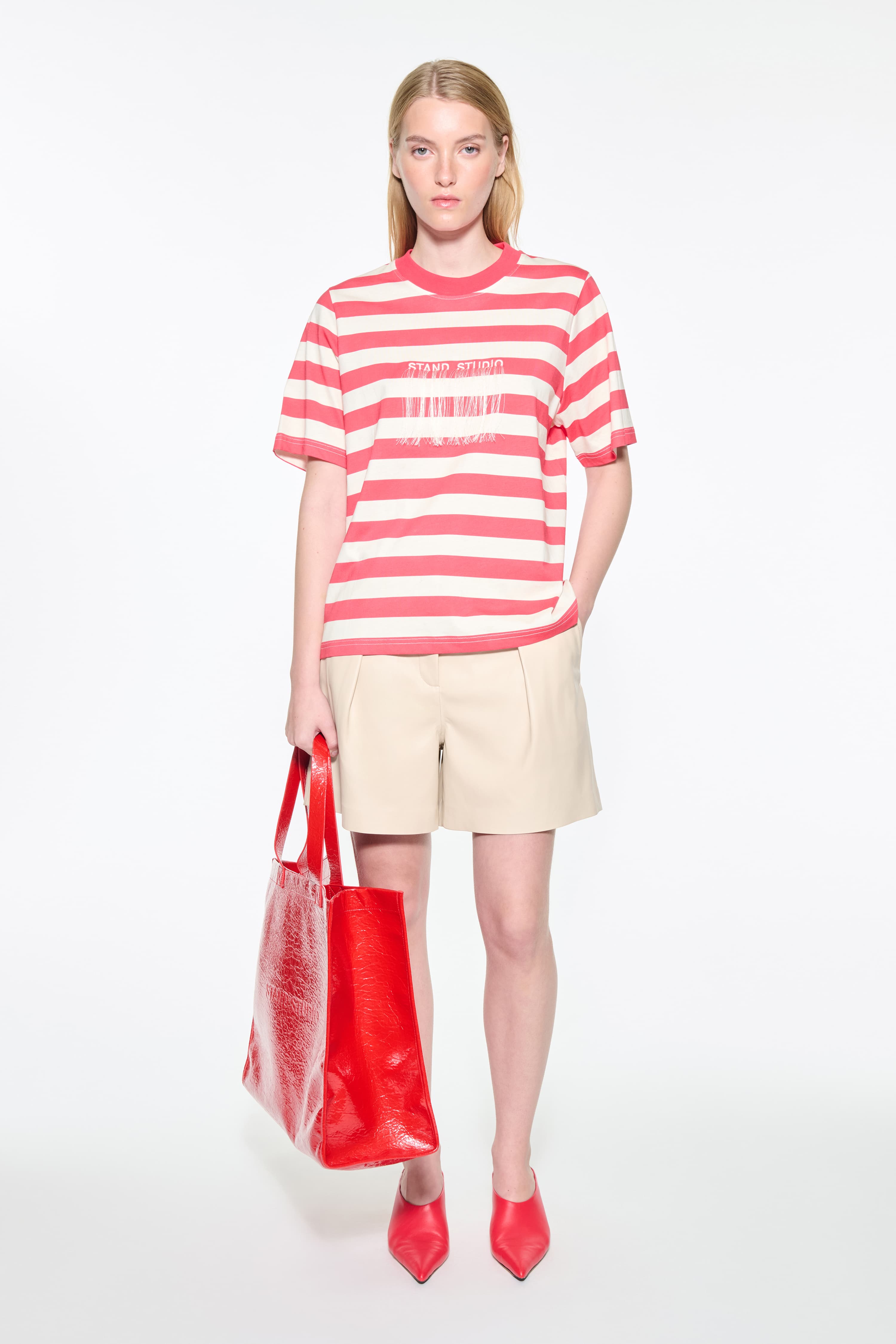 Front view of the Hallie T-Shirt in Watermelon Stripe/Fringe, Hallie Tee is a relaxed-fit striped t-shirt made from lightweight jersey fabric. The color is a red and white striped fabric.