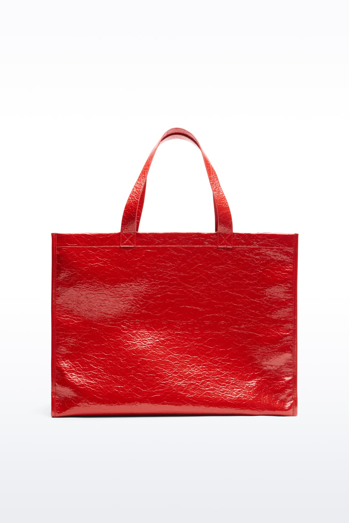 Front view of the Tiana Shopper in Watermelon, is a classic tote bag crafted in bonded faux leather with a textured finish. The color is a bold red tone.