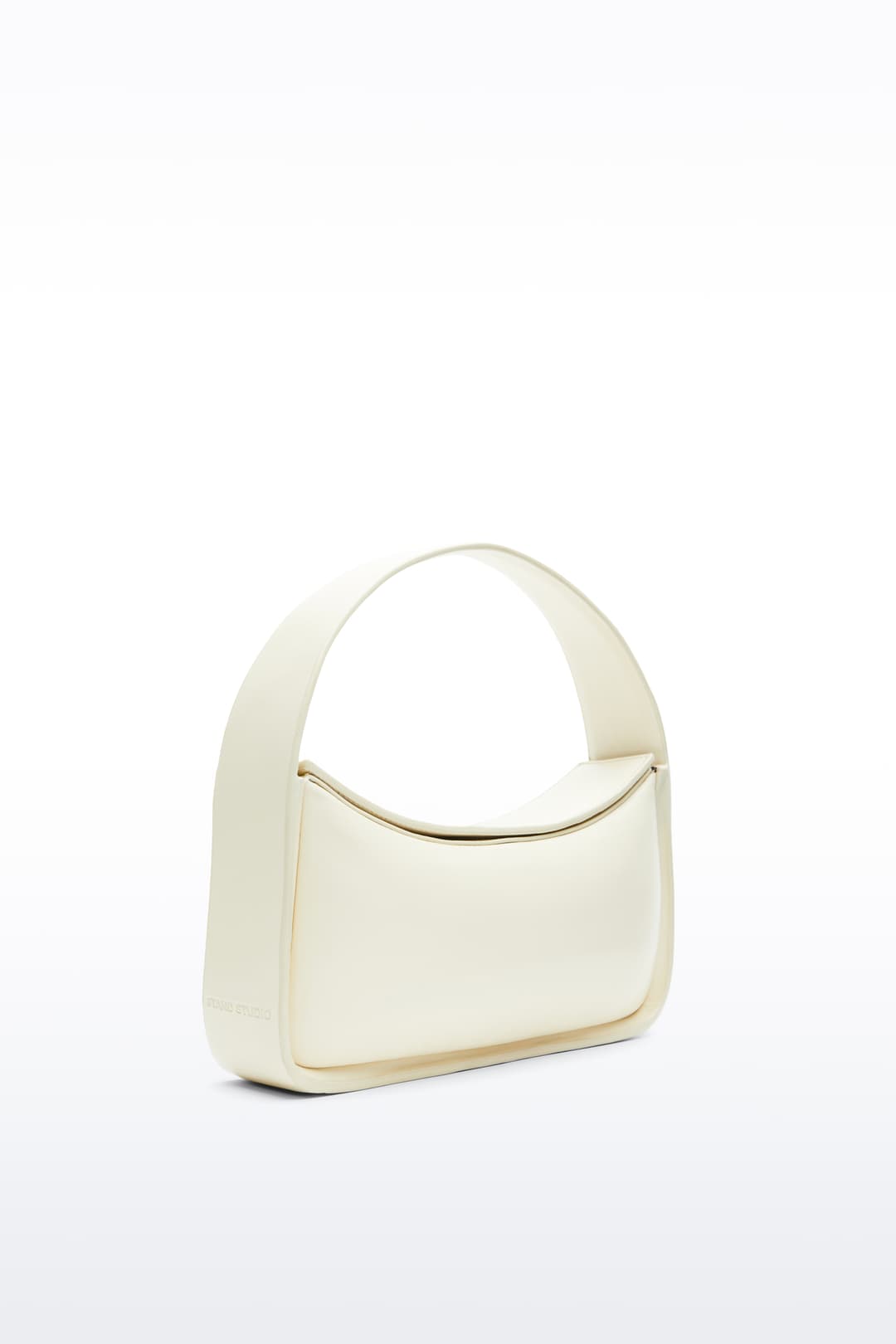 Additional view of the Dakota Bag in Pina Colada, Dakota is a handbag crafted from genuine lamb leather and designed for a sleek, baguette-shaped silhouette. The color is a pale yellow tone.