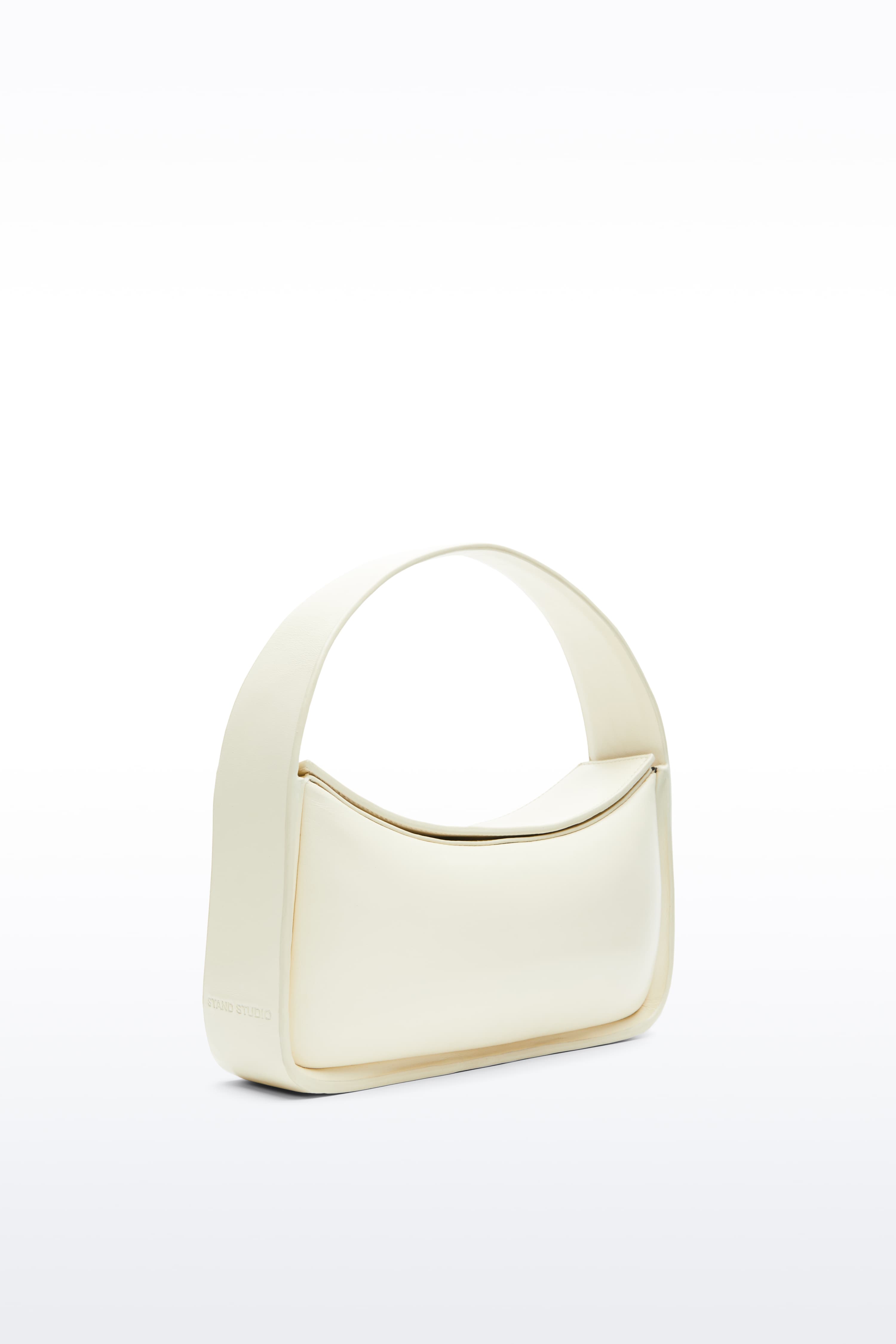 Additional view of the Dakota Bag in Pina Colada, Dakota is a handbag crafted from genuine lamb leather and designed for a sleek, baguette-shaped silhouette. The color is a pale yellow tone.