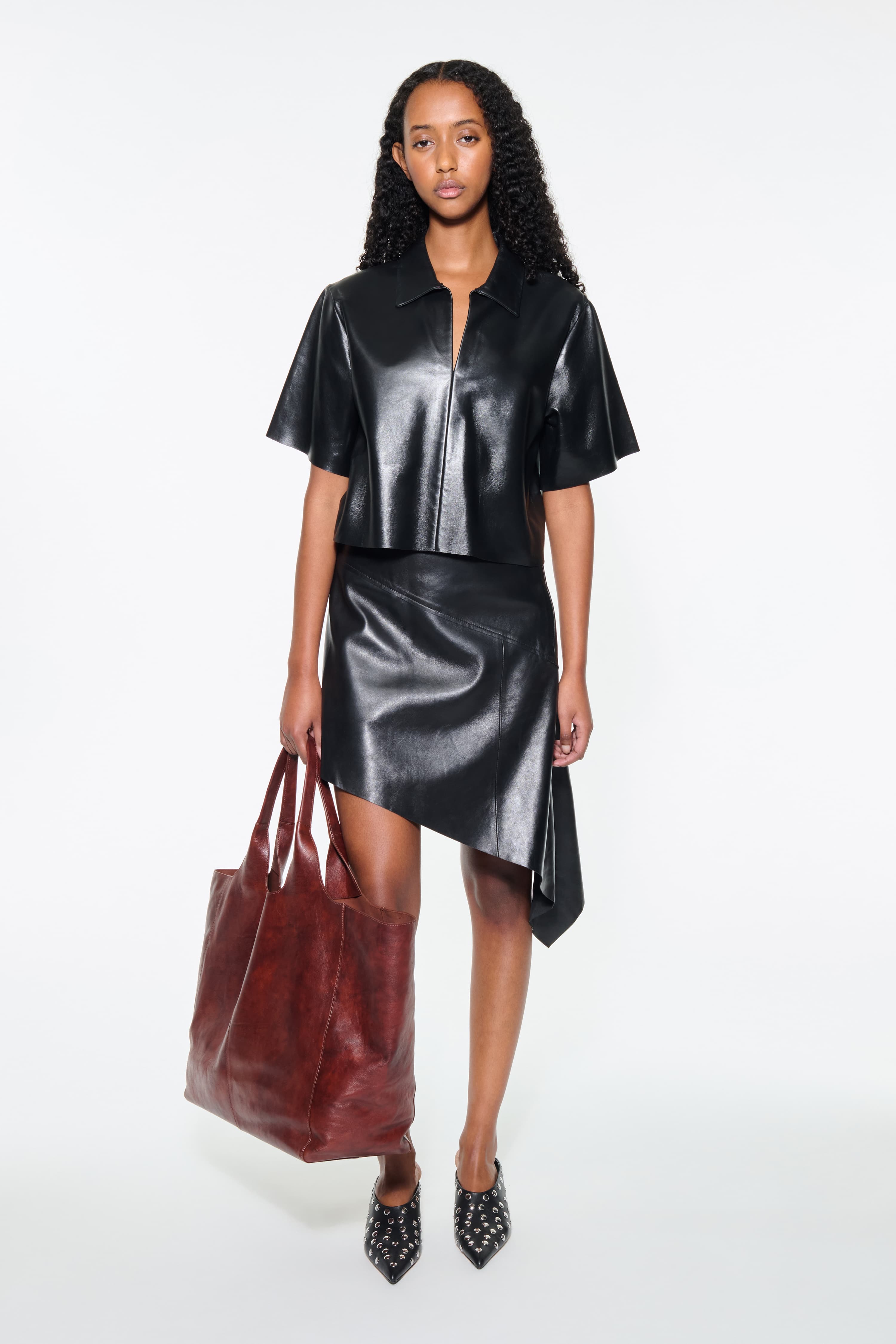 Front view of the Julissa Shirt in Black, is designed in leather with a relaxed silhouette.