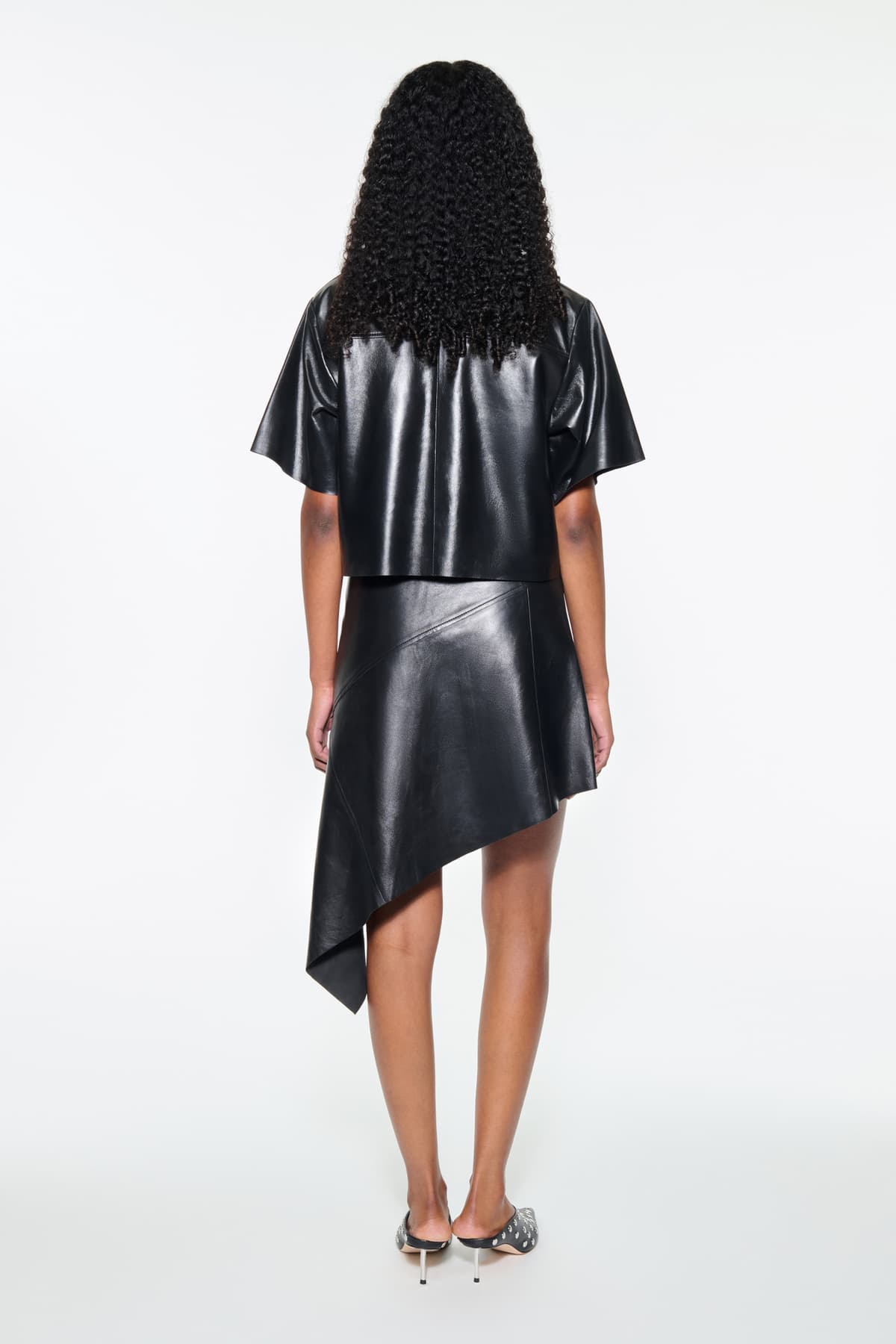 Back view of the Julissa Shirt in Black, is designed in leather with a relaxed silhouette.
