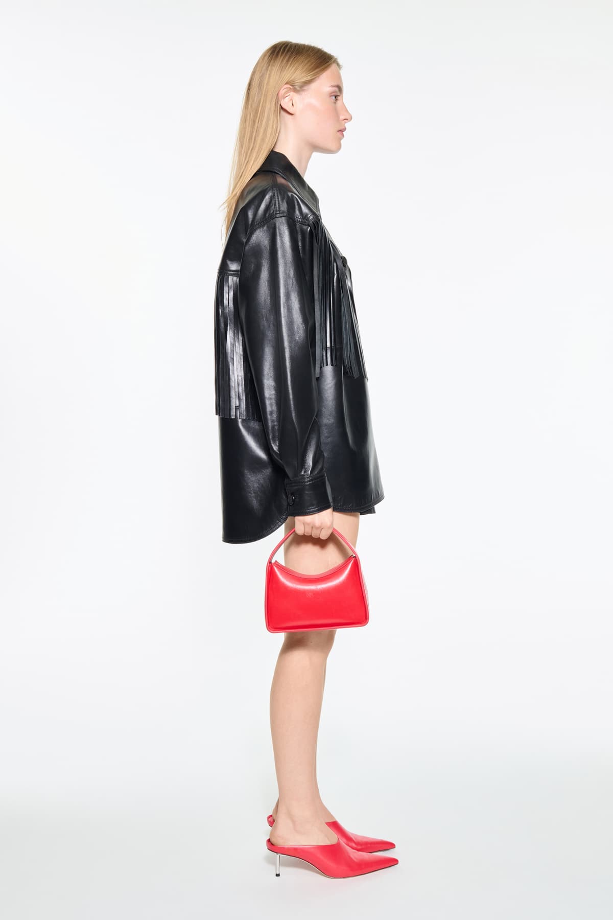 Side view of the Saskia Fringe Shirt in Black, Saskia Shirt is crafted from leather with a soft, flowing silhouette.