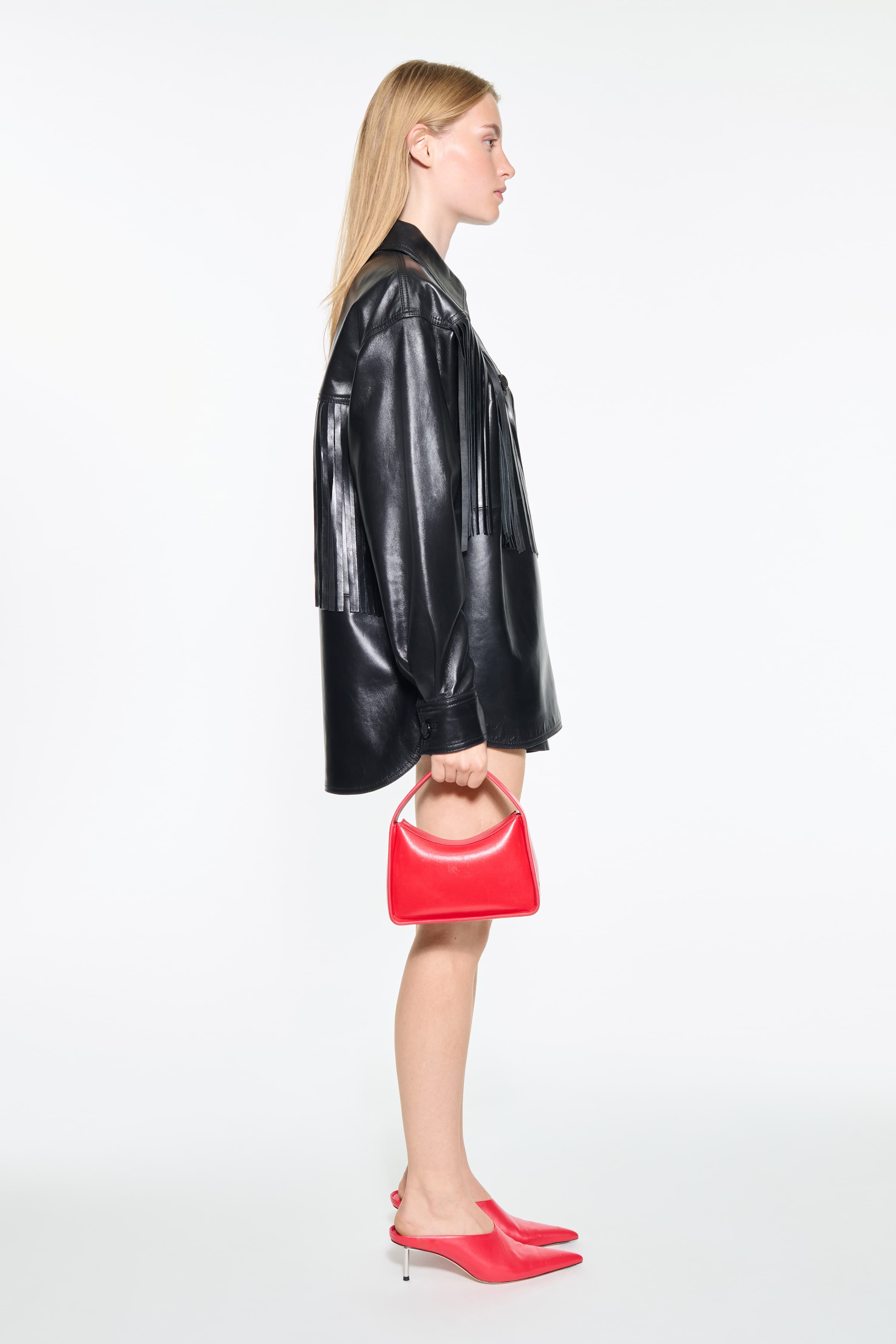 Side view of the Saskia Fringe Shirt in Black, Saskia Shirt is crafted from leather with a soft, flowing silhouette.