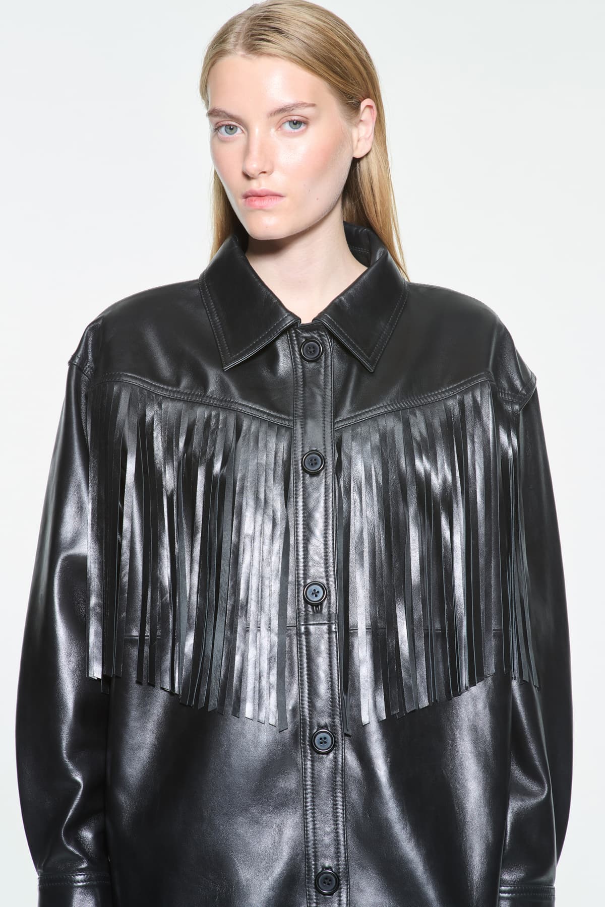 Close-up view of the Saskia Fringe Shirt in Black, Saskia Shirt is crafted from leather with a soft, flowing silhouette.