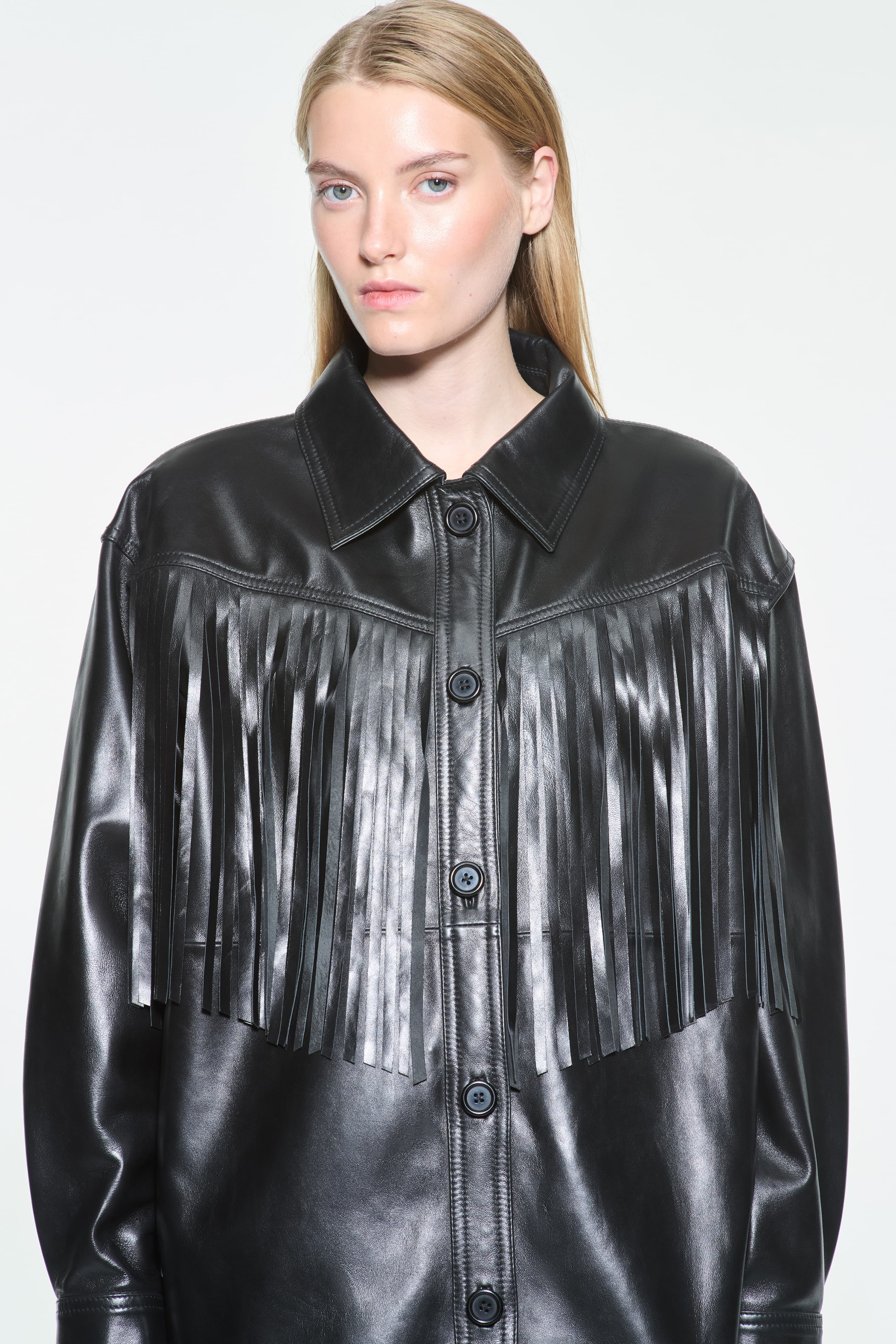 Close-up view of the Saskia Fringe Shirt in Black, Saskia Shirt is crafted from leather with a soft, flowing silhouette.
