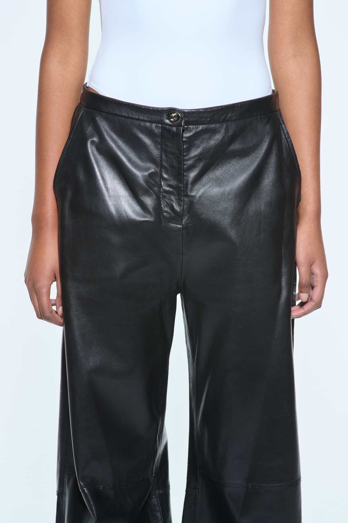 Close-up view of the Rowyn Trousers in Black, are crafted in leather and are designed for a wide silhouette.