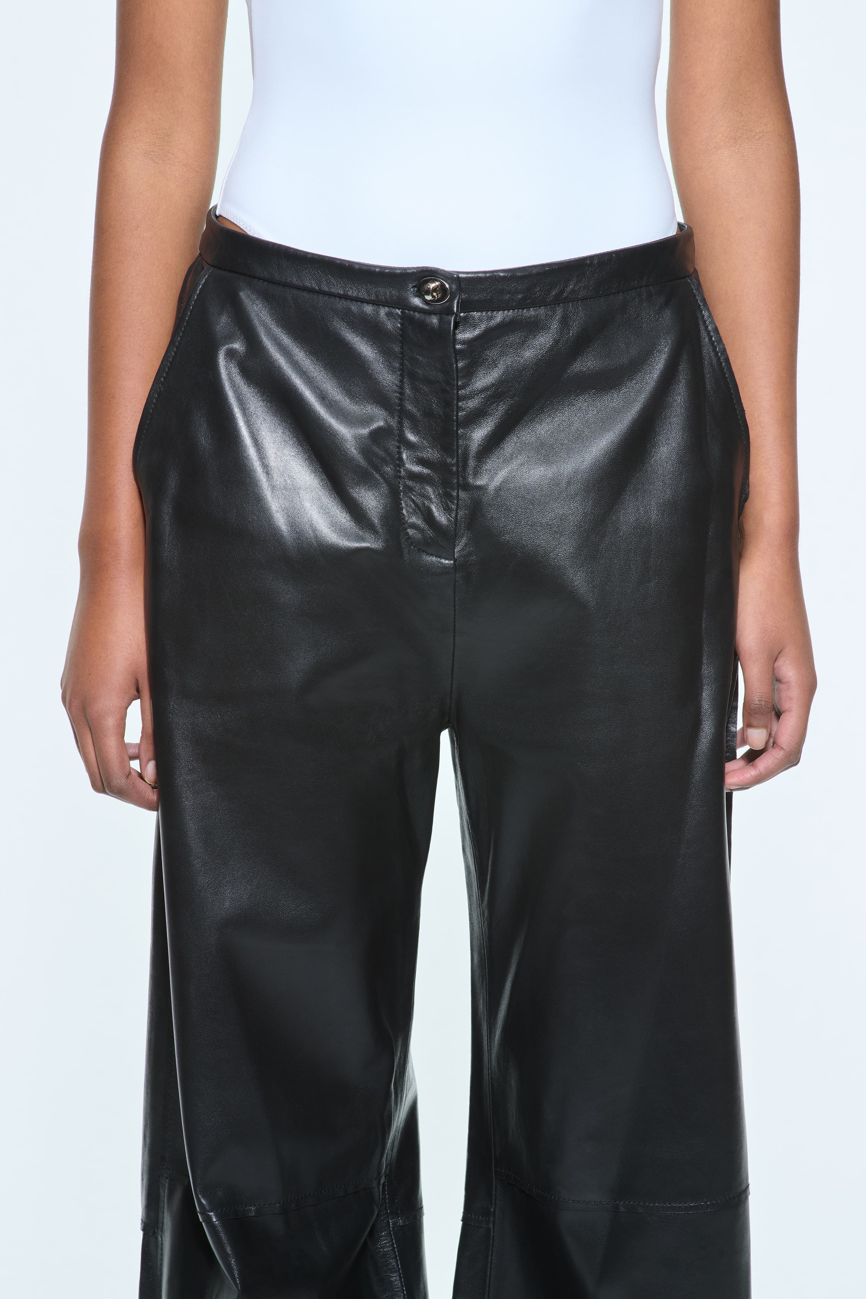 Close-up view of the Rowyn Trousers in Black, are crafted in leather and are designed for a wide silhouette.