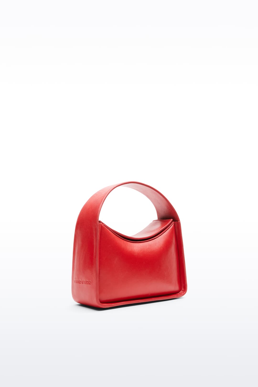 Additional view of the Minnie II Bag in Watermelon, is a handbag crafted from genuine lamb leather. The color is a bold red tone.