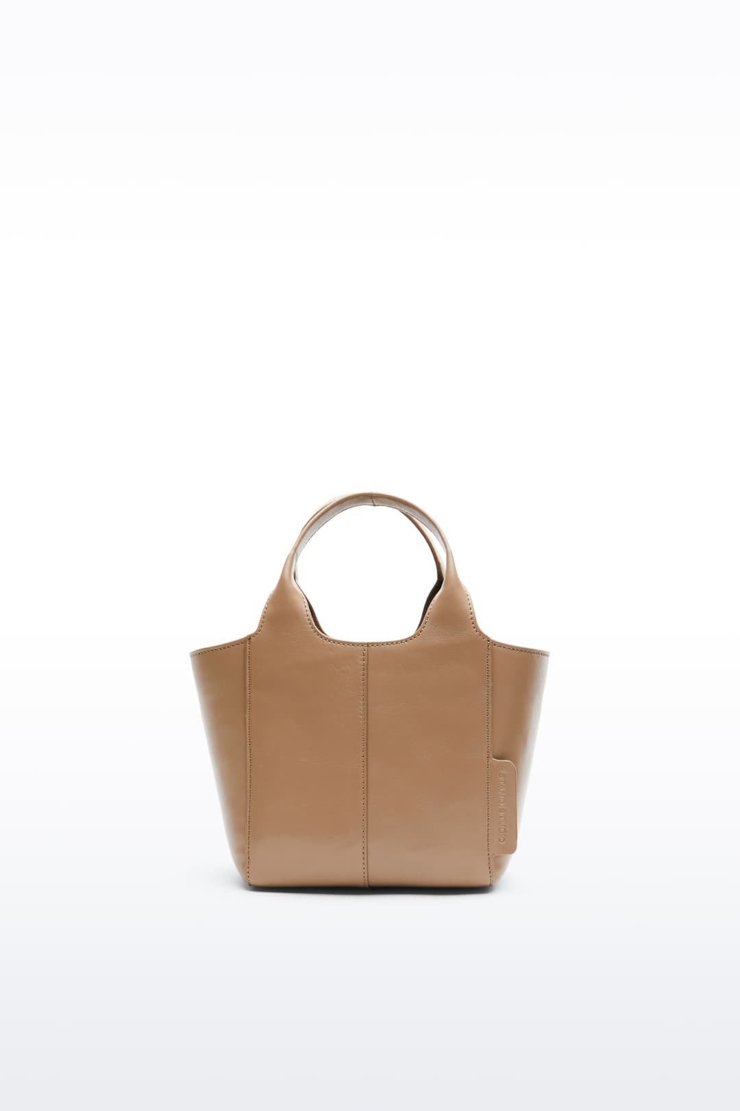 Front view of the Lois Mini Bag in Coconut Brown, is a smaller bag made in leather. The color is a light brown shade.