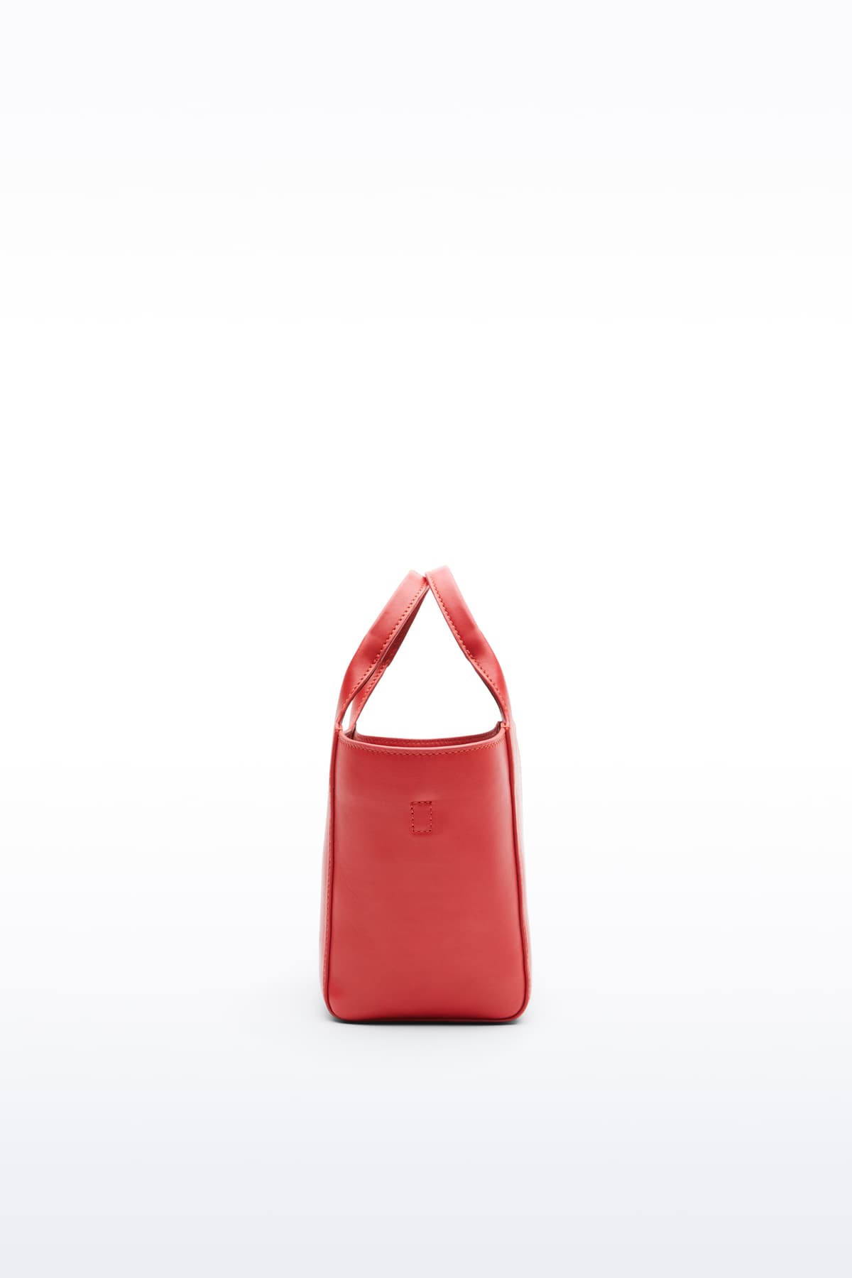 Additional view of the Lois Mini Bag in Watermelon, is a smaller bag made in leather. The color is a bold red tone.