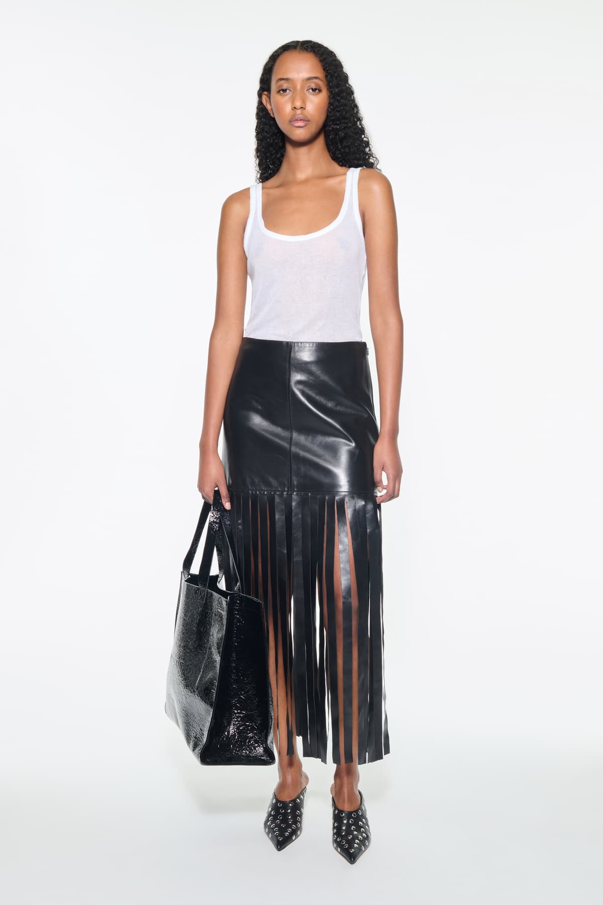 Front view of the Amoura Top in White, is a tank top crafted from soft ribbed fabric.