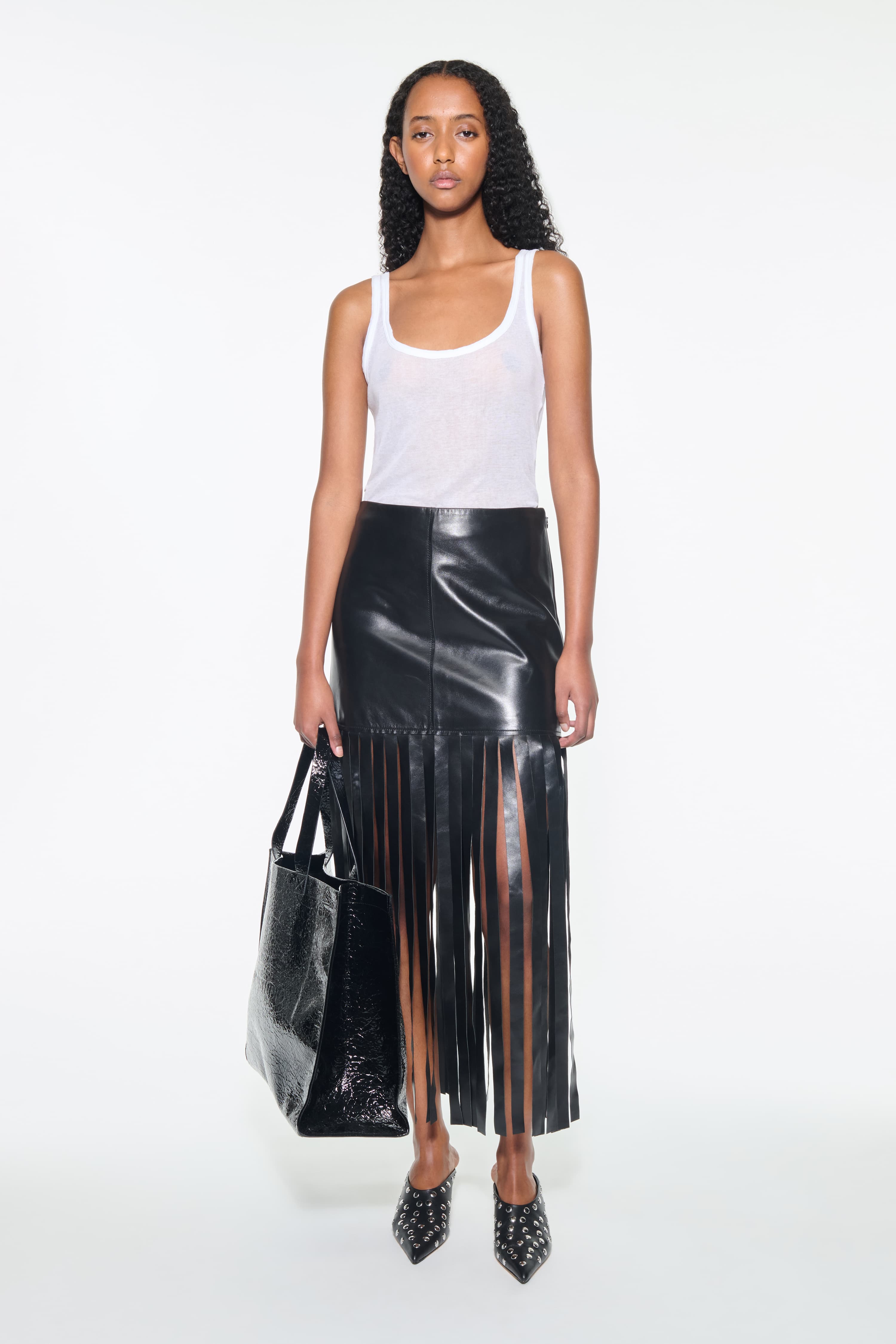 Front view of the Amoura Top in White, is a tank top crafted from soft ribbed fabric.