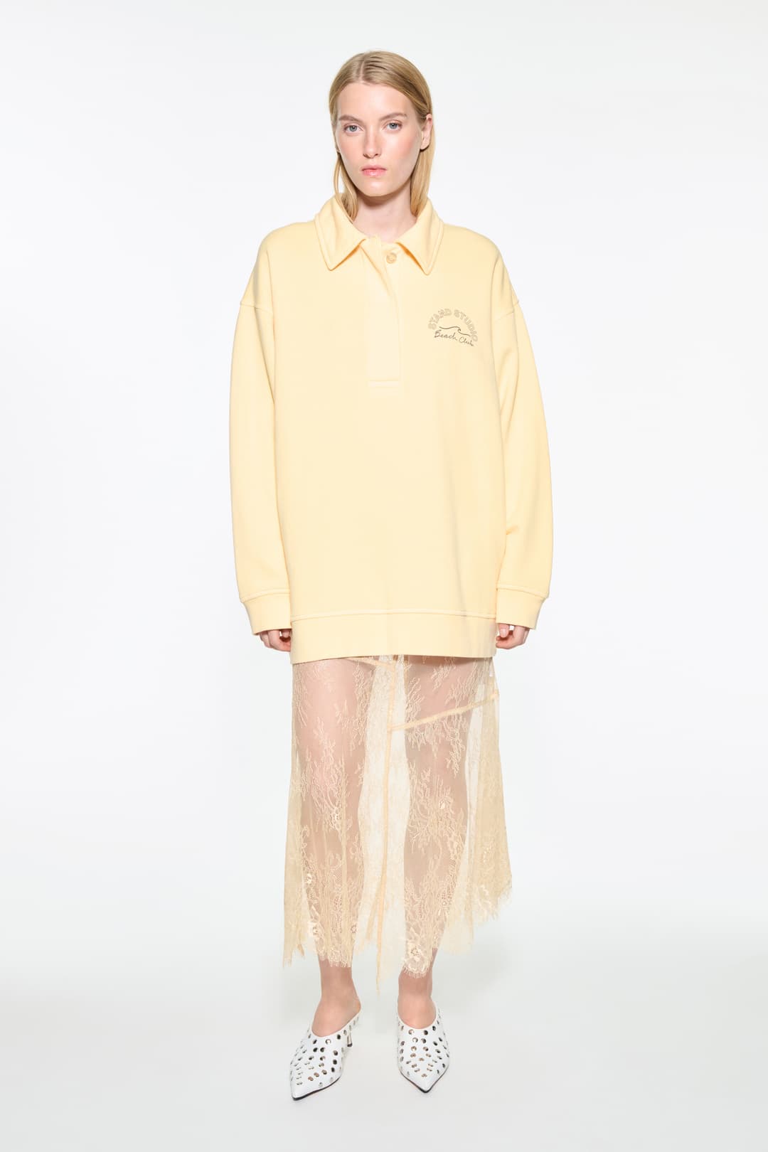 Front view of the Emberynn Sweatshirt in Pina Colada/Beach Club, is a relaxed sweatshirt featuring a classic polo collar and a concealed button placket. The color is similar to pale yellow.