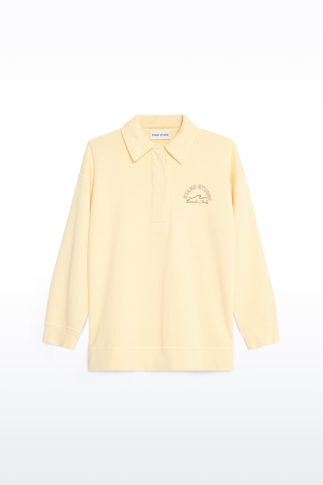 Packshot of the Emberynn Sweatshirt in Pina Colada/Beach Club, is a relaxed sweatshirt featuring a classic polo collar and a concealed button placket. The color is similar to pale yellow.