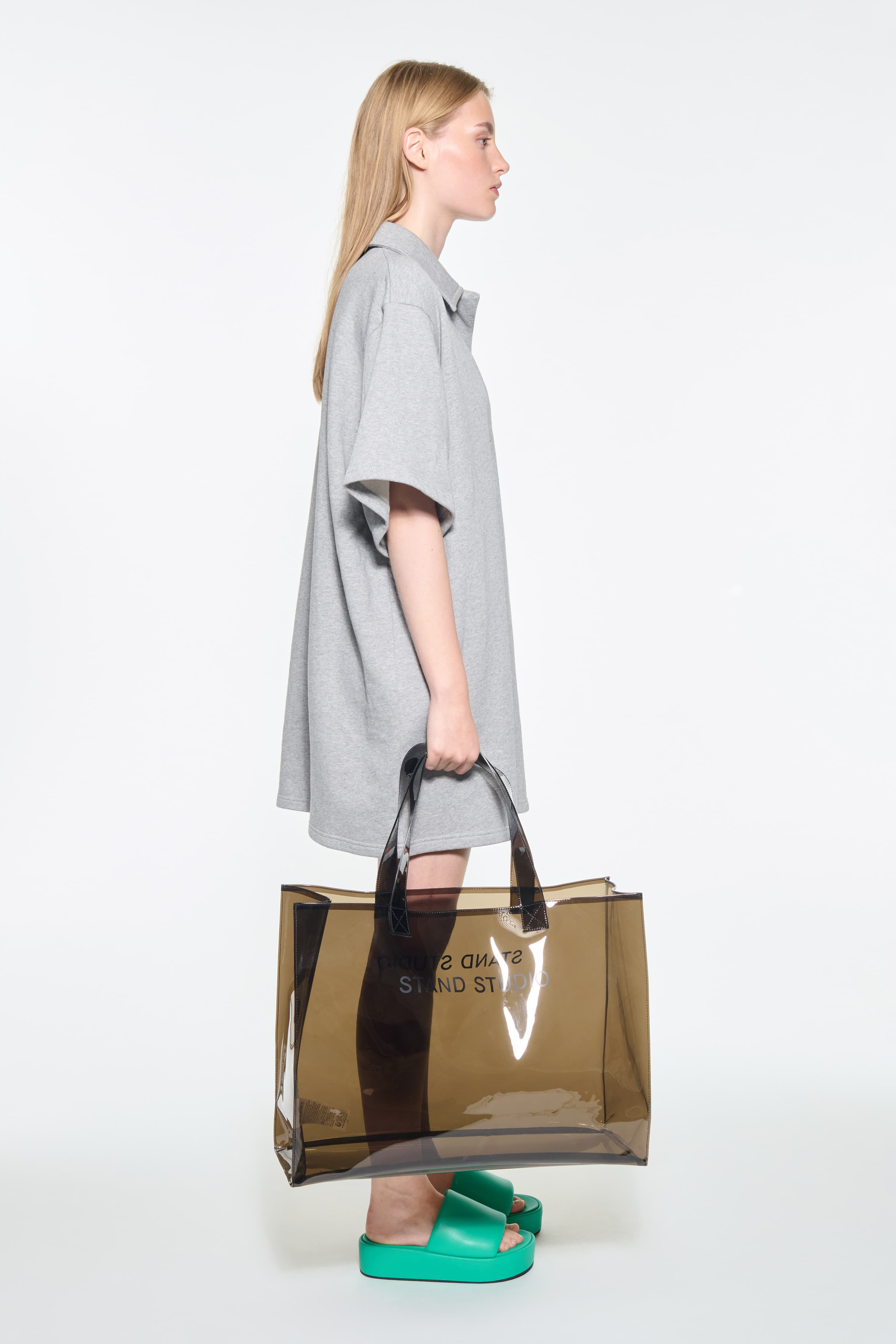 Side view of the Kennedi Polo Dress in Grey Melange/Logo, is a casual, knee-length dress with a polo collar made from lightweight jersey fabric.