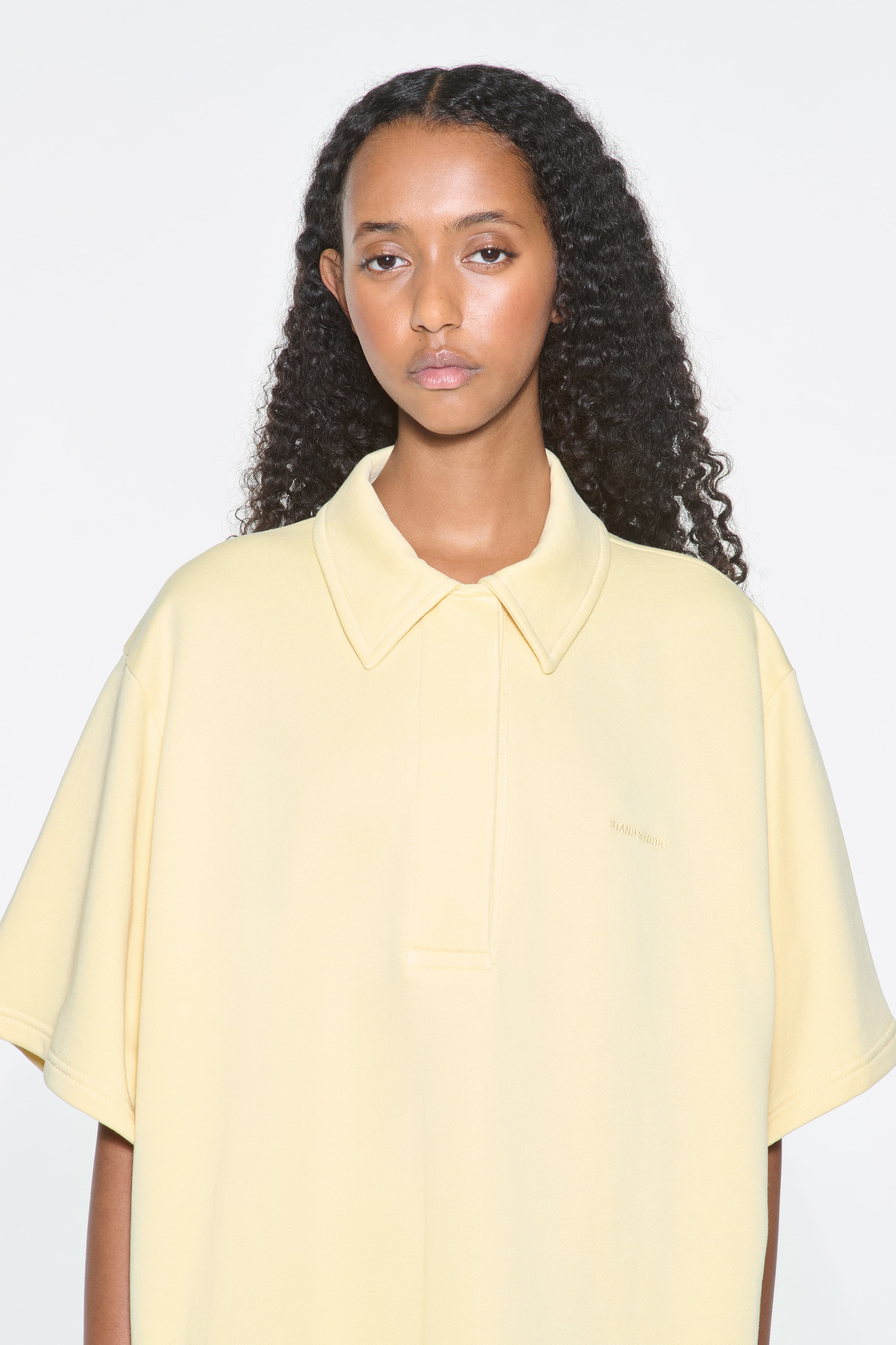 Close-up view of the Kennedi Polo Dress in Pina Colada/Logo, is a casual, knee-length dress with a polo collar made from lightweight jersey fabric.