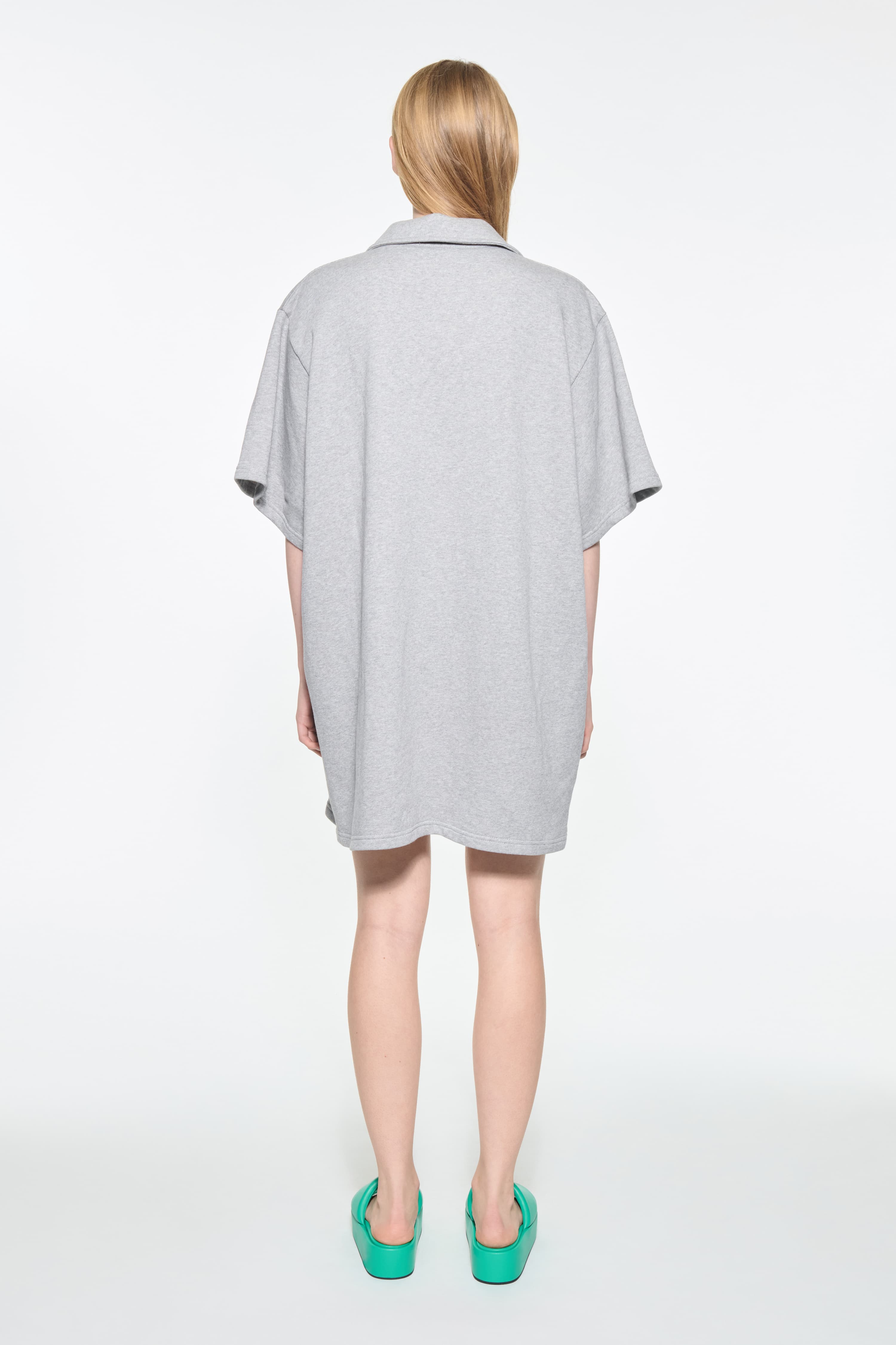 Back view of the Kennedi Polo Dress in Grey Melange/Logo, is a casual, knee-length dress with a polo collar made from lightweight jersey fabric.