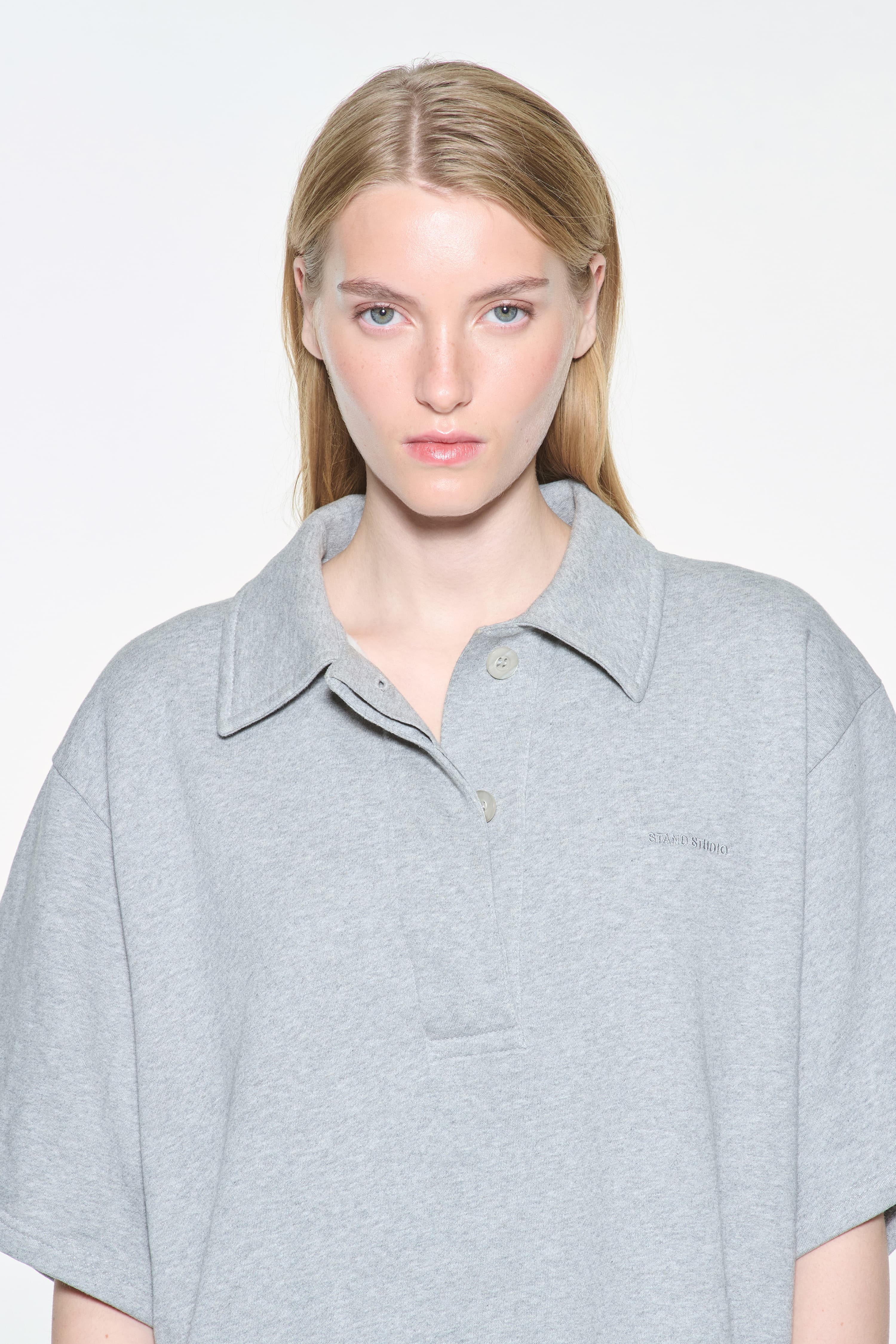 Close-up view of the Kennedi Polo Dress in Grey Melange/Logo, is a casual, knee-length dress with a polo collar made from lightweight jersey fabric.