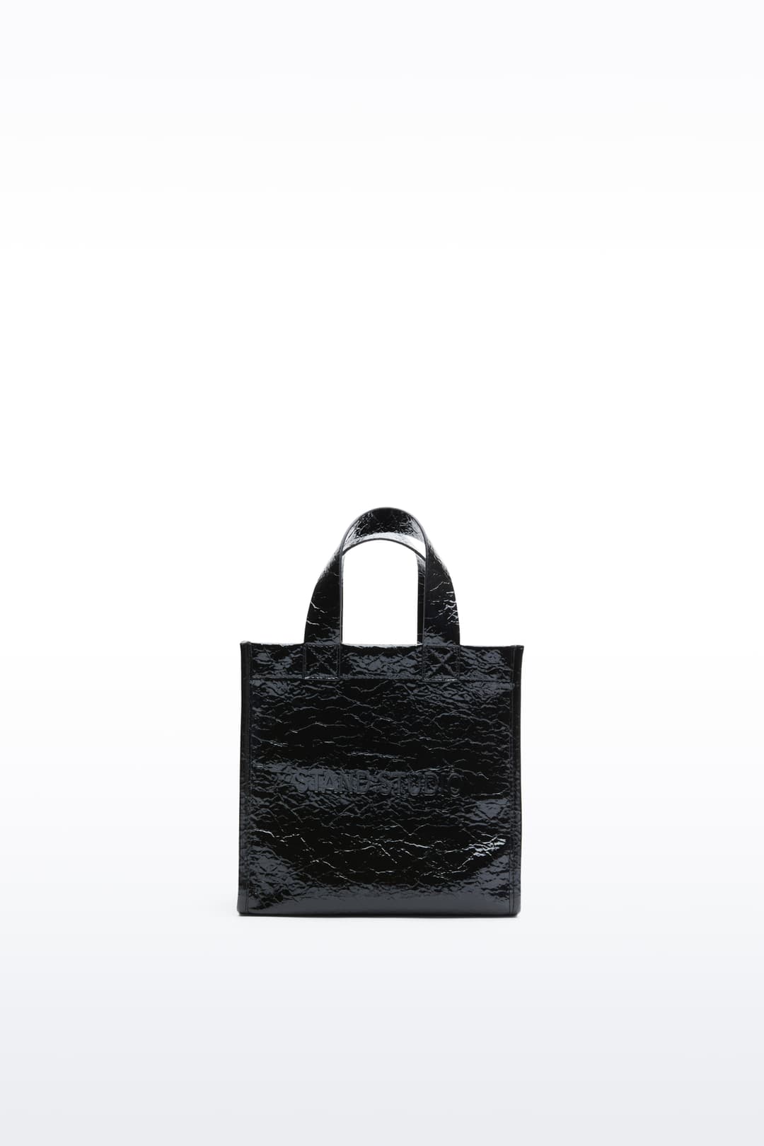 Front view of the Tiana Mini Shopper in Black, is a small-scale adaptation of the Tiana Shopper, crafted in faux leather with a sleek, structured silhouette.