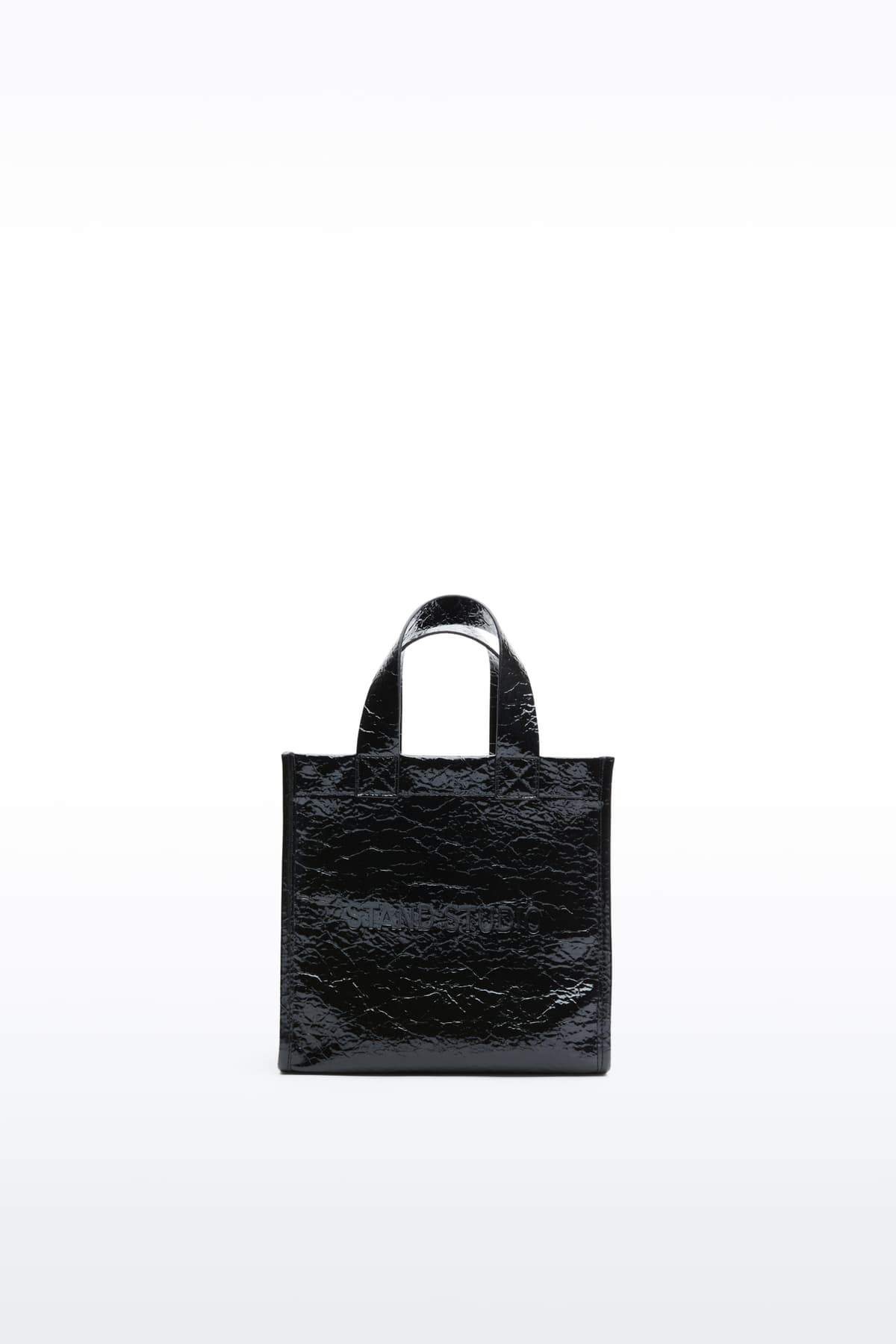 Front view of the Tiana Mini Shopper in Black, is a small-scale adaptation of the Tiana Shopper, crafted in faux leather with a sleek, structured silhouette.