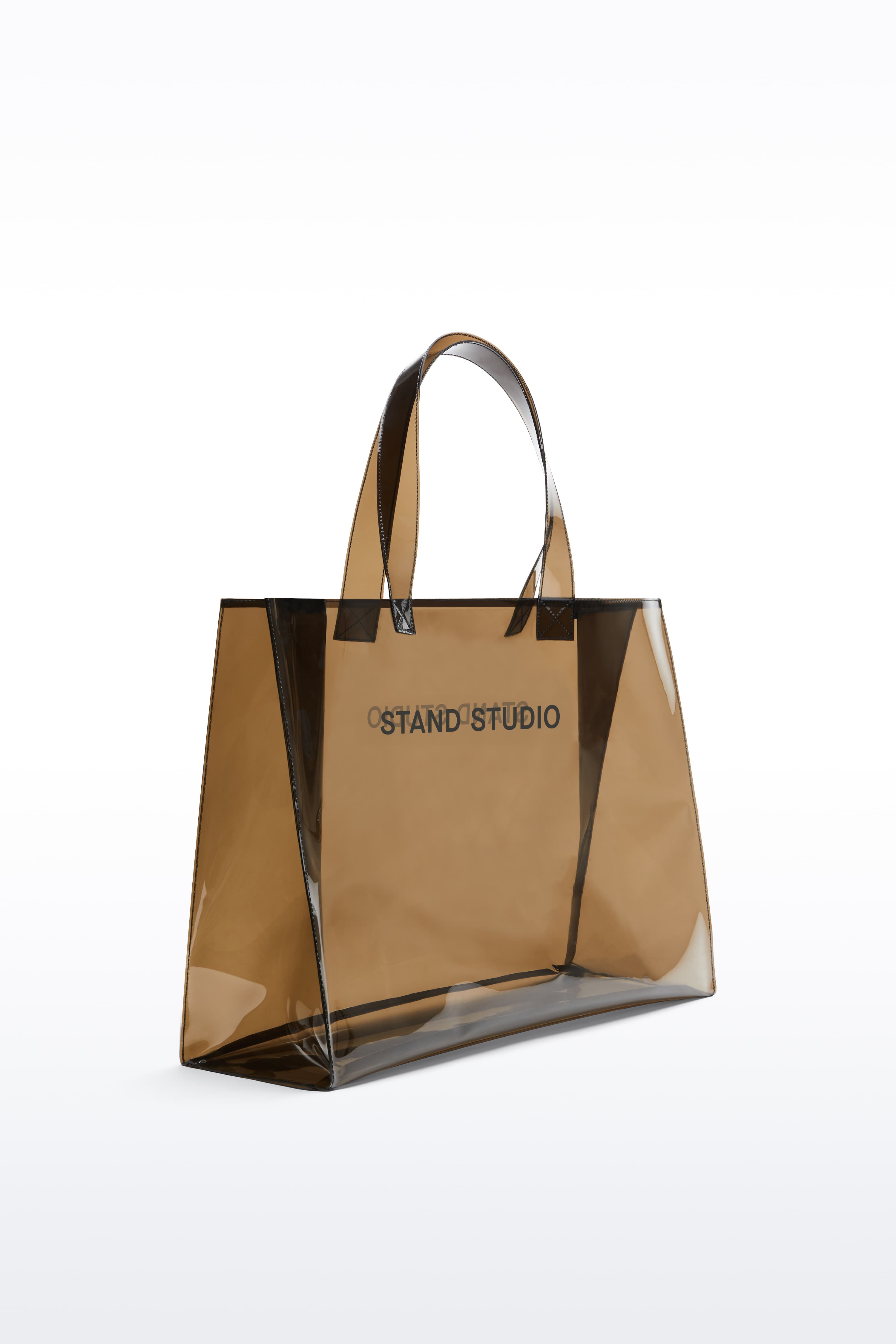 Additional view of the Tina Tote in Black, is a spacious everyday bag crafted from transparent material.