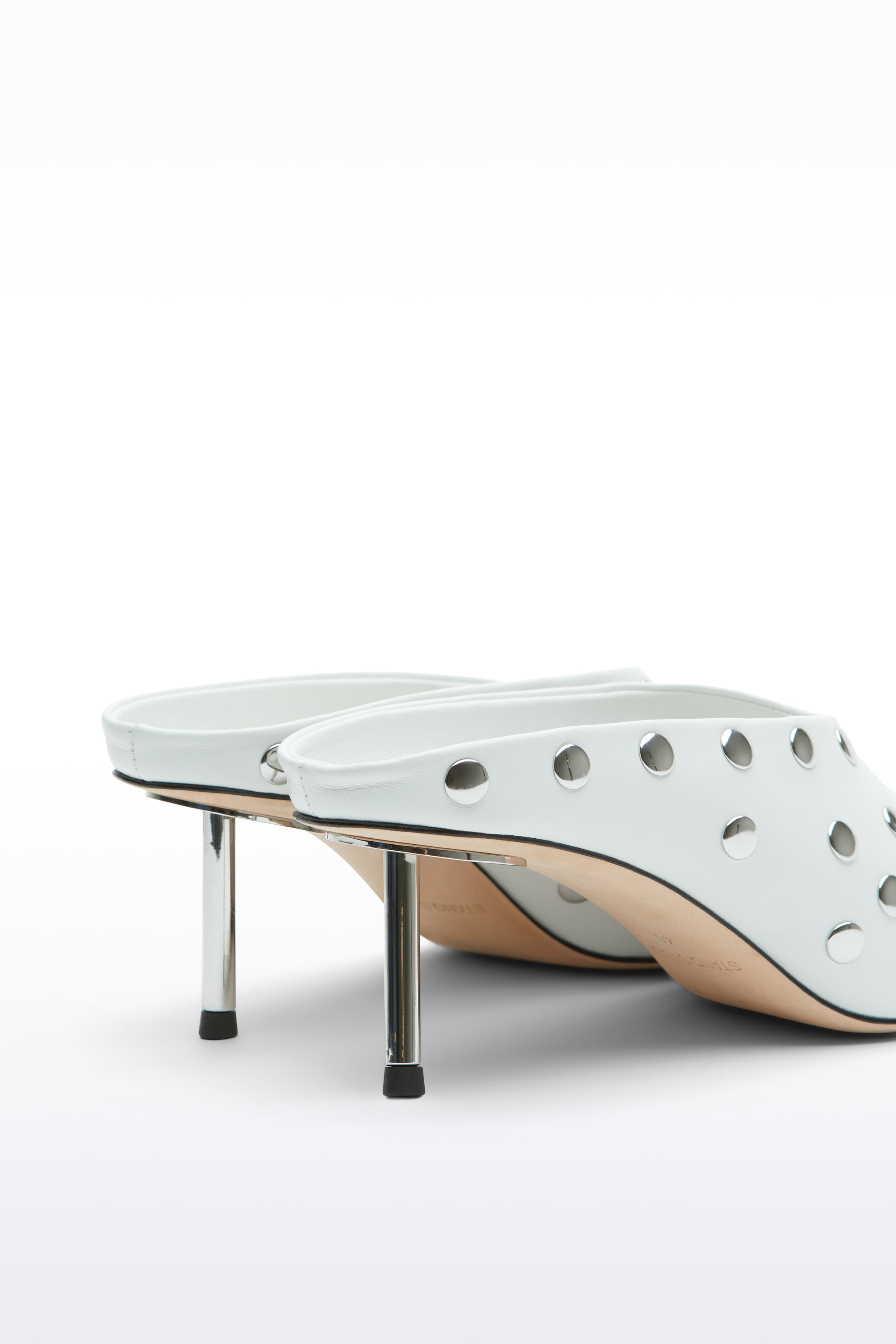 Close-up view of the Kelsey Studded Mule in White, Kelsey Mule is a slip-on mule crafted in smooth nappa leather with sleek metallic studs.