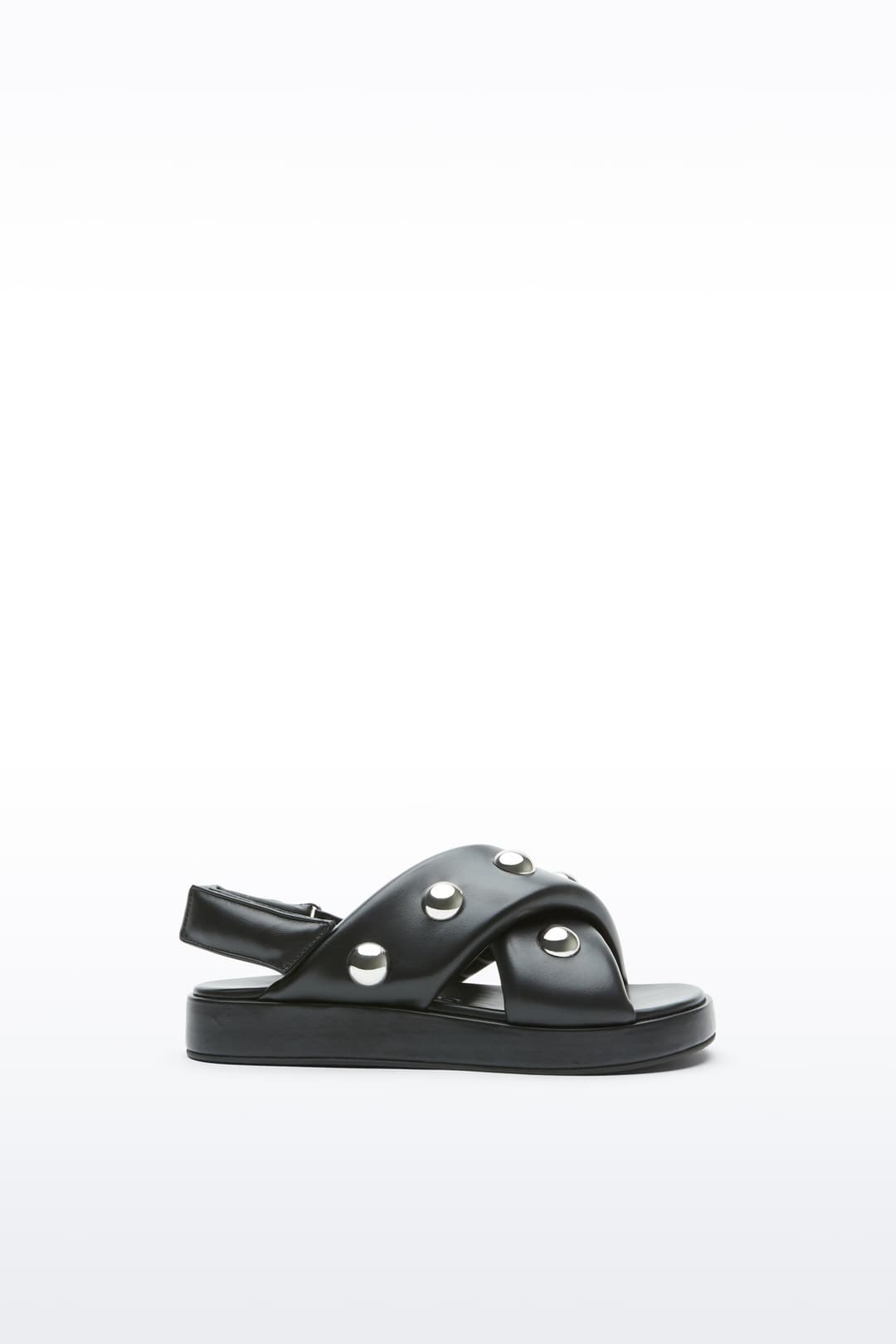 Side view of the Sammy Sandal in Black, is a bold sandal with voluminously padded straps and silver ball-stud detailing.