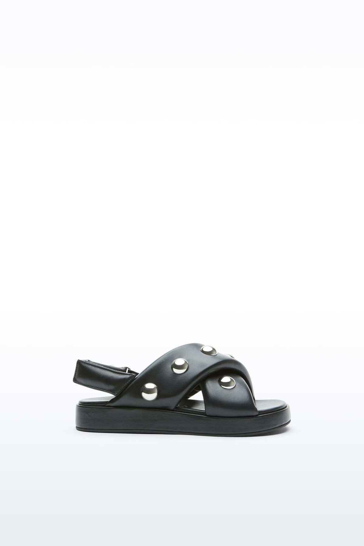 Side view of the Sammy Sandal in Black, is a bold sandal with voluminously padded straps and silver ball-stud detailing.