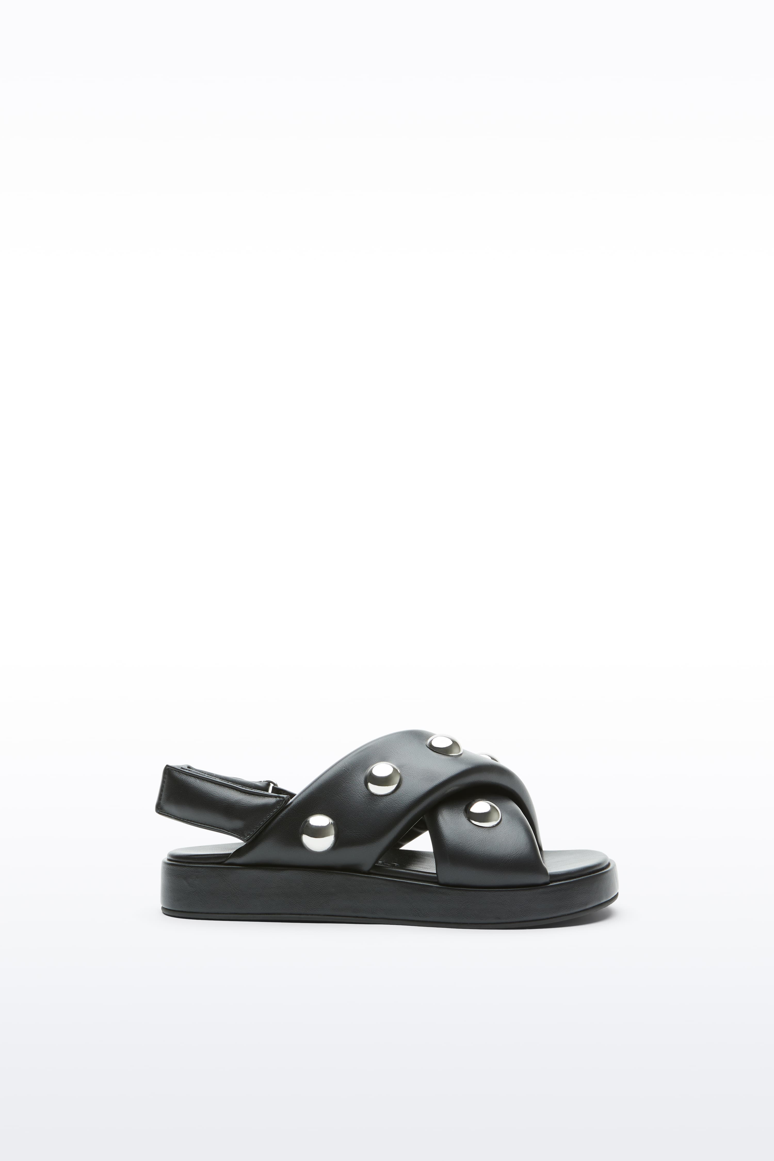 Side view of the Sammy Sandal in Black, is a bold sandal with voluminously padded straps and silver ball-stud detailing.