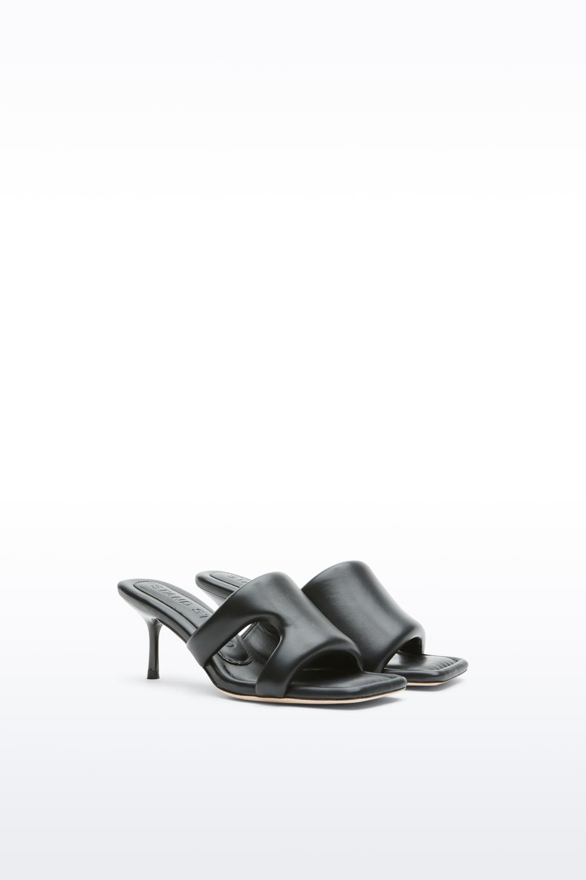 Additional view of the Molly Mule in Black, is a minimalist mule featuring a padded faux leather upper and a sleek silhouette.