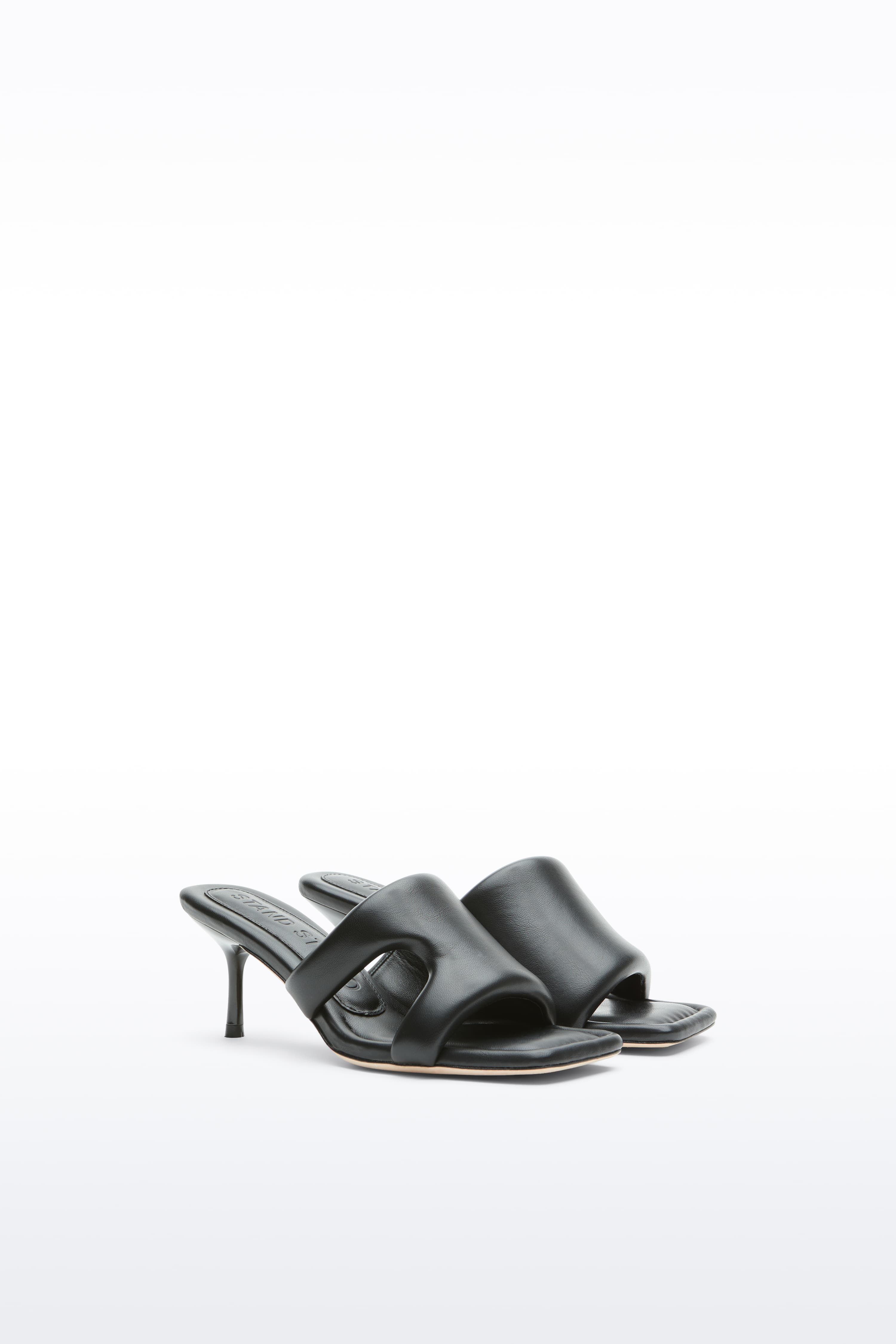 Additional view of the Molly Mule in Black, is a minimalist mule featuring a padded faux leather upper and a sleek silhouette.