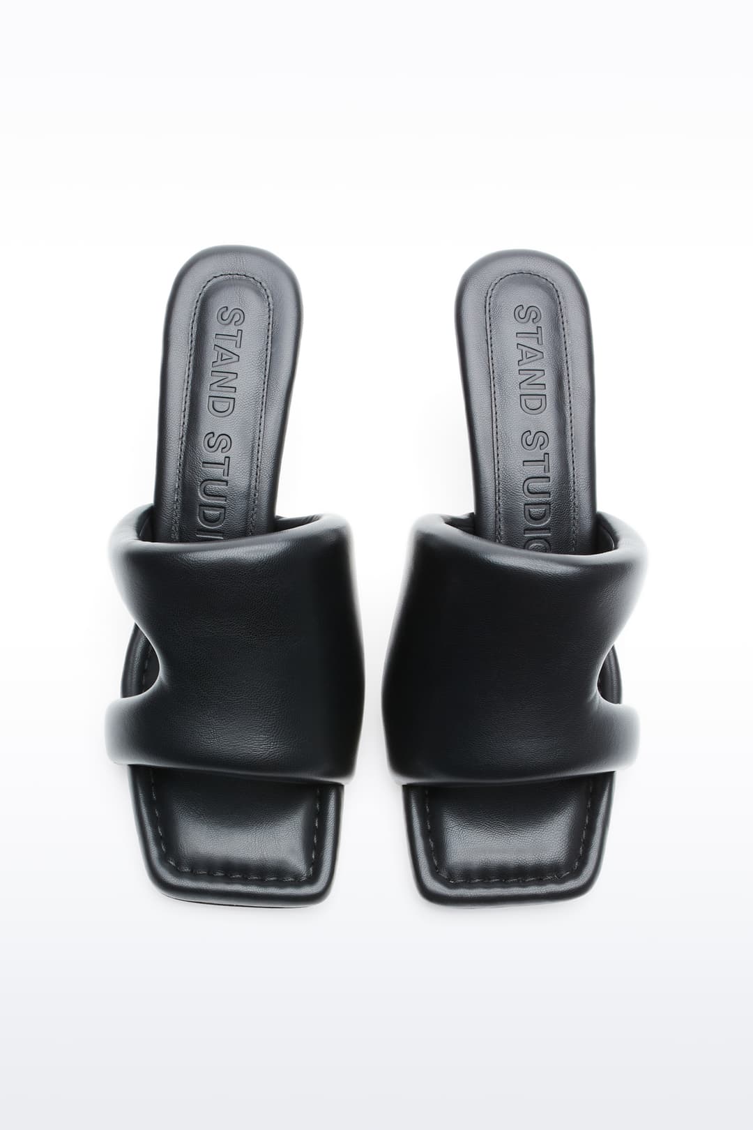 Above view of Molly Mule in Black, is a minimalist mule featuring a padded faux leather upper and a sleek silhouette.