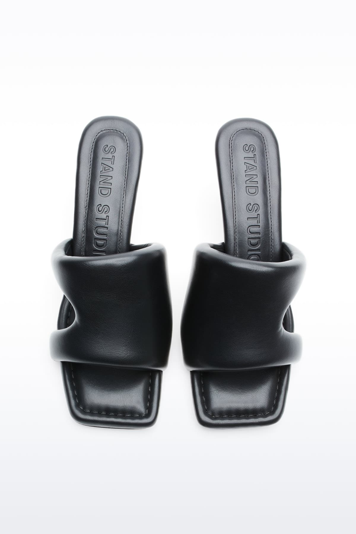 Above view of Molly Mule in Black, is a minimalist mule featuring a padded faux leather upper and a sleek silhouette.