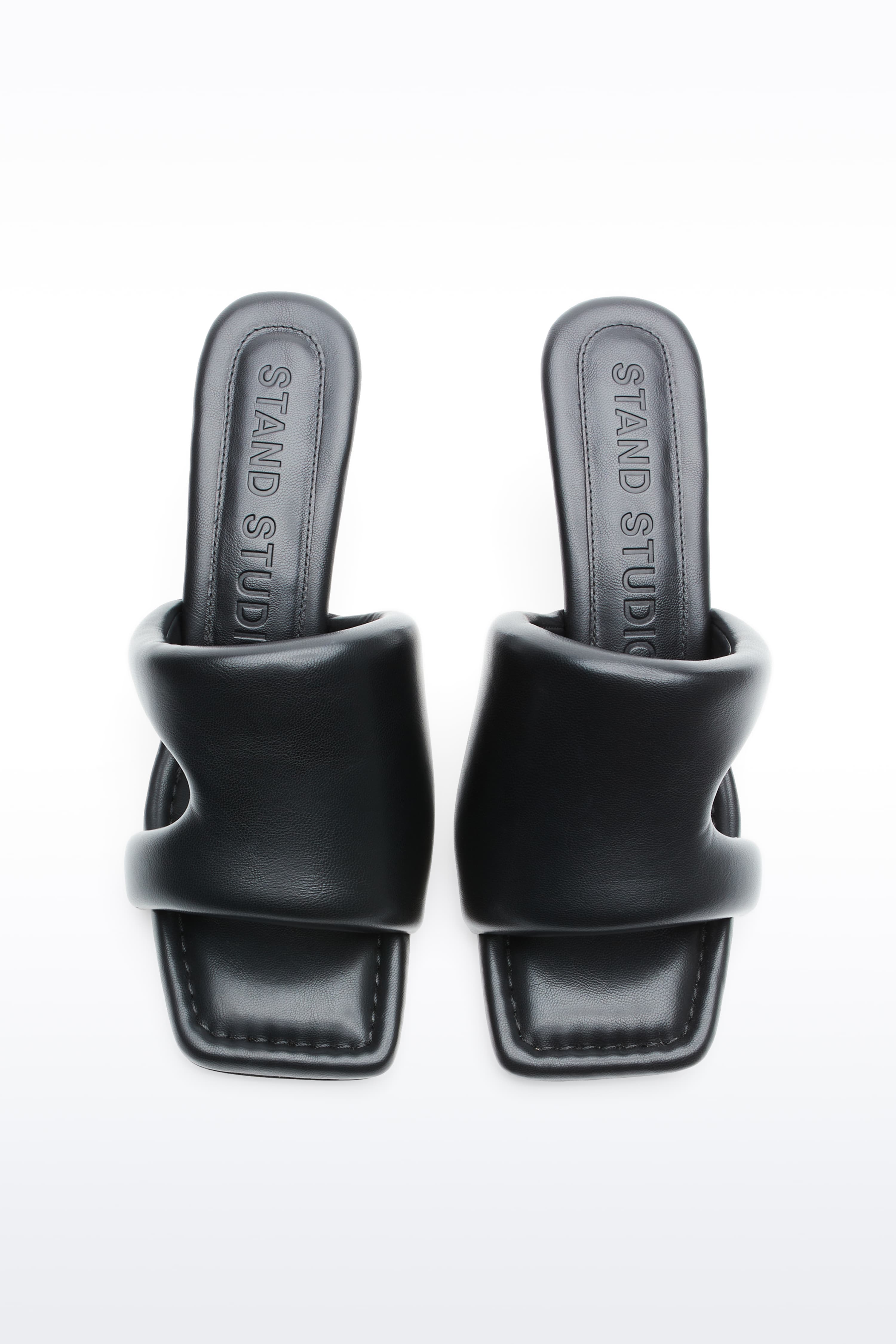 Above view of Molly Mule in Black, is a minimalist mule featuring a padded faux leather upper and a sleek silhouette.