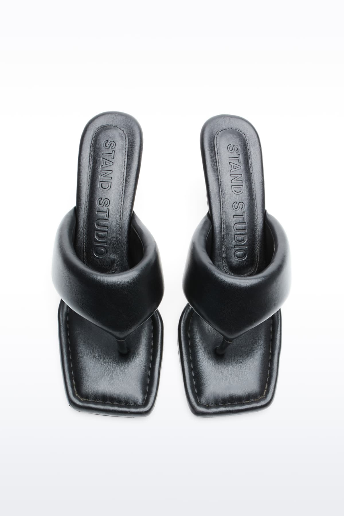 Above view of Jessica Mule in Black, Jessica Padded Mule is a heeled mule featuring a padded faux leather upper with a sleek thong-strap design.