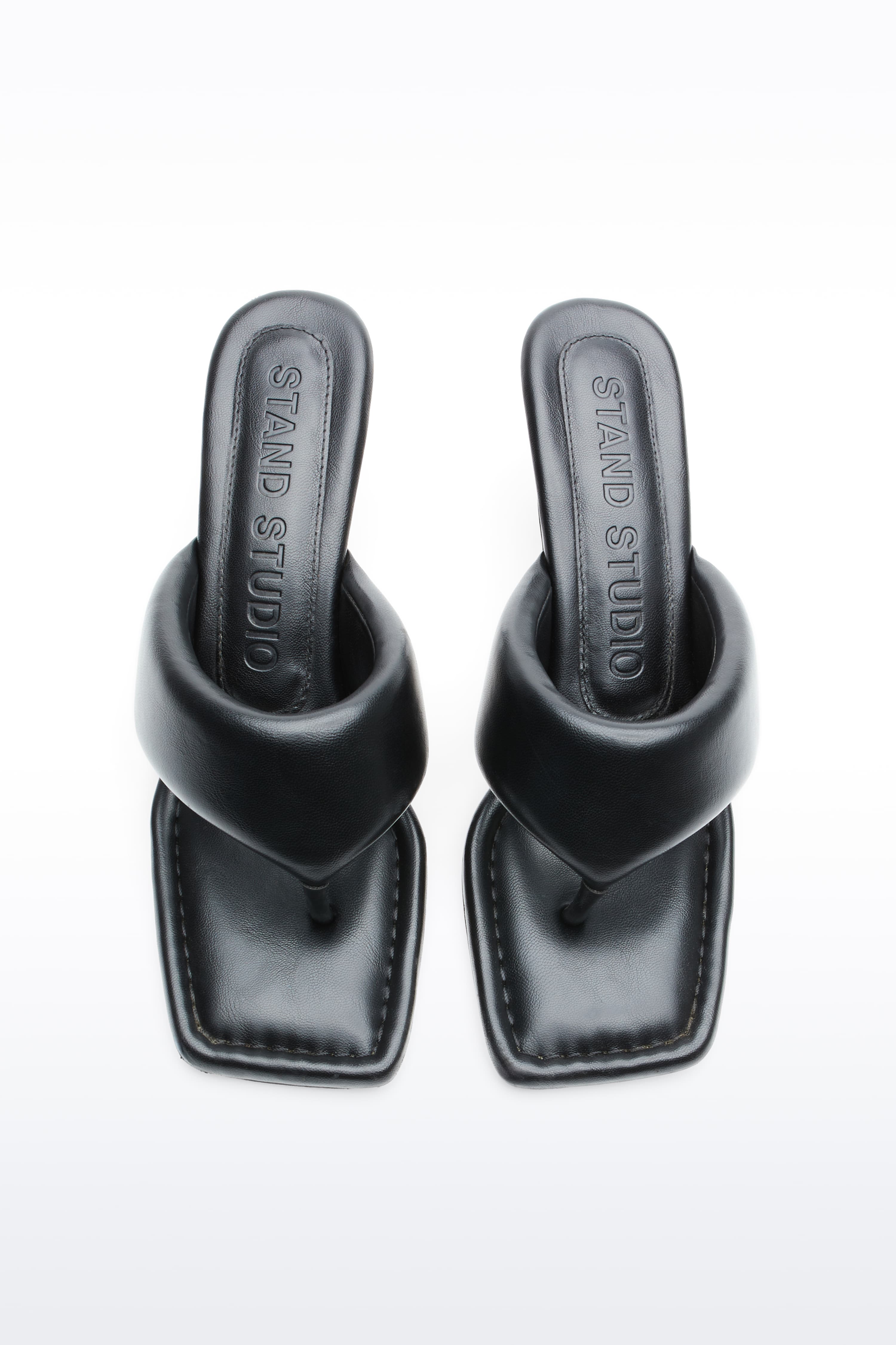 Above view of Jessica Mule in Black, Jessica Padded Mule is a heeled mule featuring a padded faux leather upper with a sleek thong-strap design.