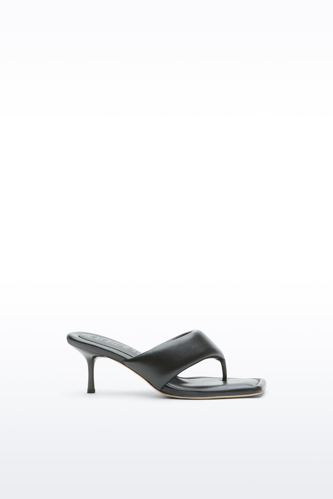 Side view of the Jessica Mule in Black, Jessica Padded Mule is a heeled mule featuring a padded faux leather upper with a sleek thong-strap design.