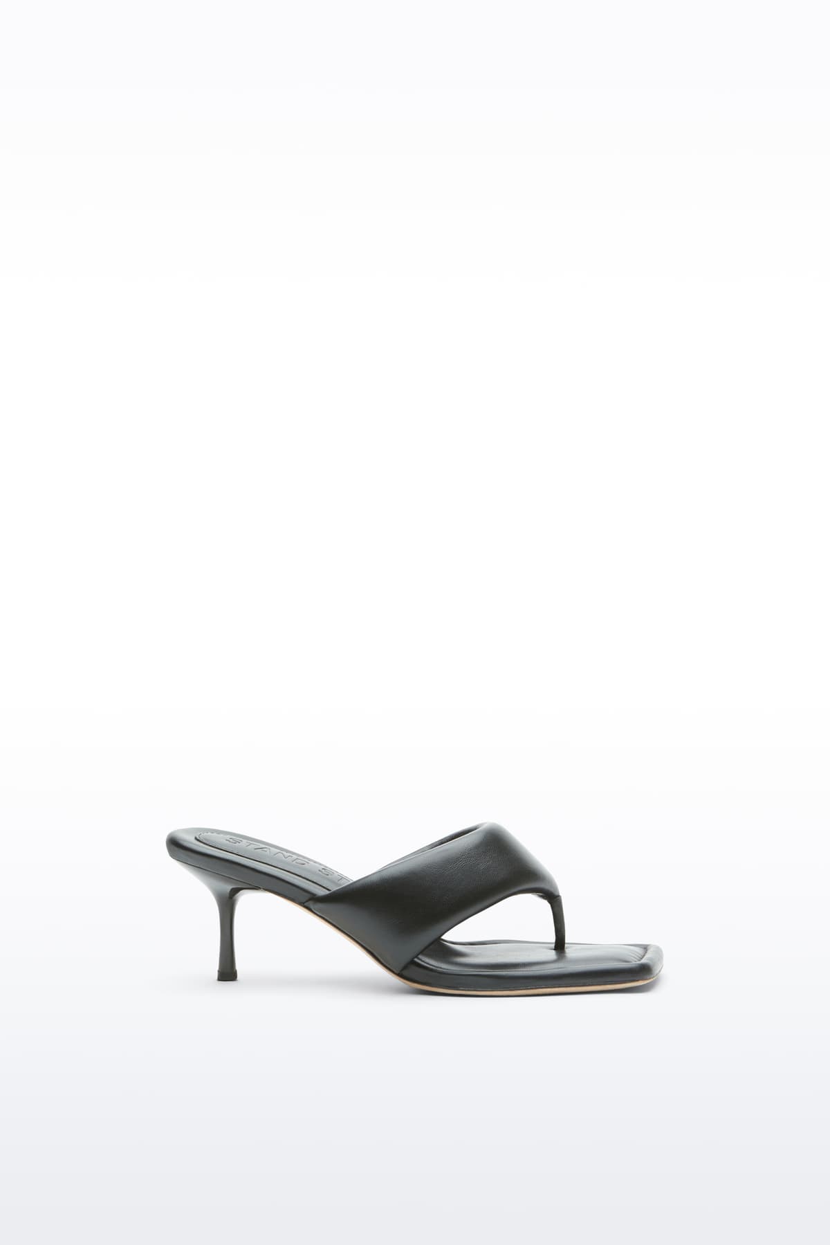 Side view of the Jessica Mule in Black, Jessica Padded Mule is a heeled mule featuring a padded faux leather upper with a sleek thong-strap design.