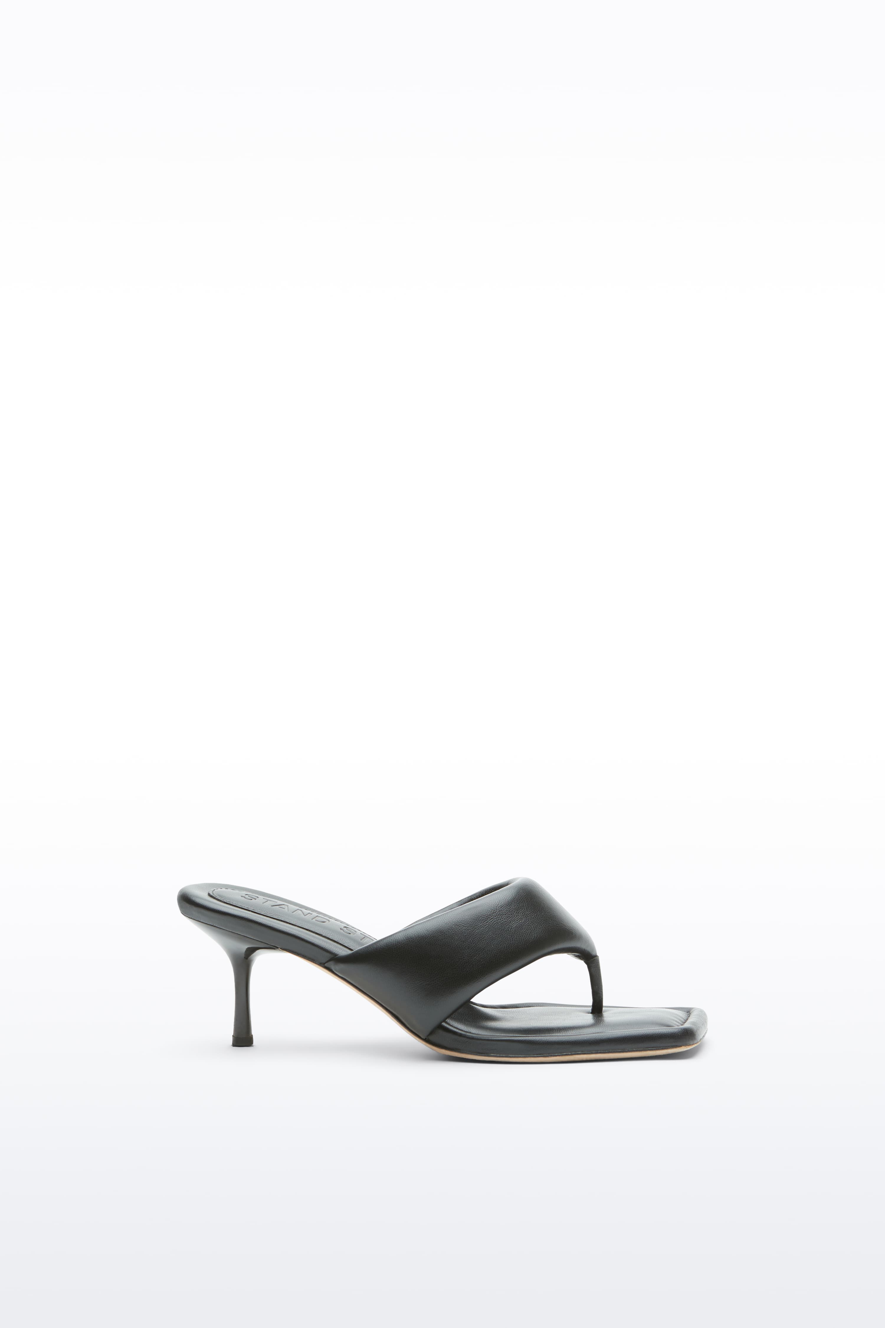 Side view of the Jessica Mule in Black, Jessica Padded Mule is a heeled mule featuring a padded faux leather upper with a sleek thong-strap design.