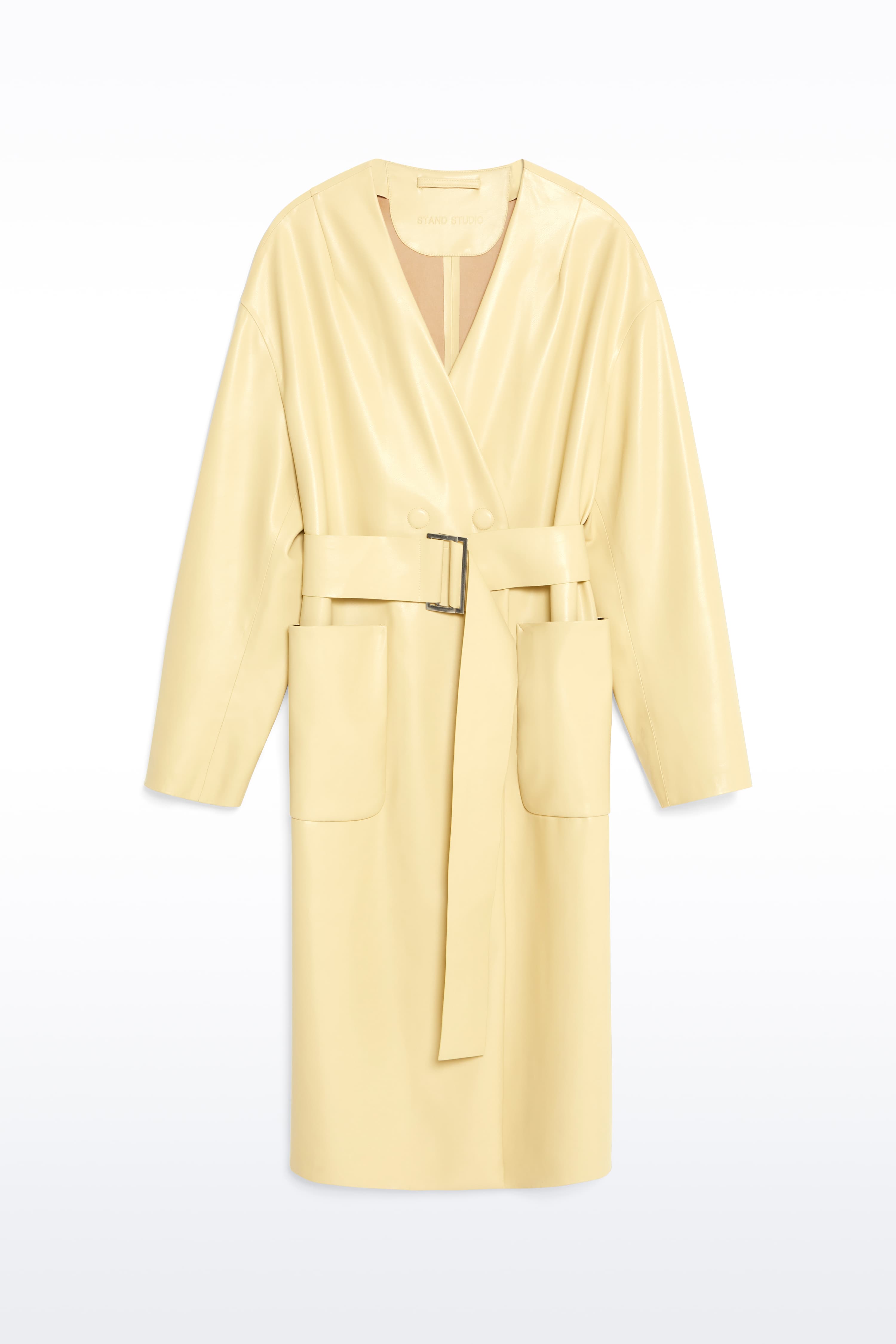 Packshot of the Valeria Coat in Pina Colada, is a faux leather coat with a wrap design and a belted waist. The color is a pale yellow tone.