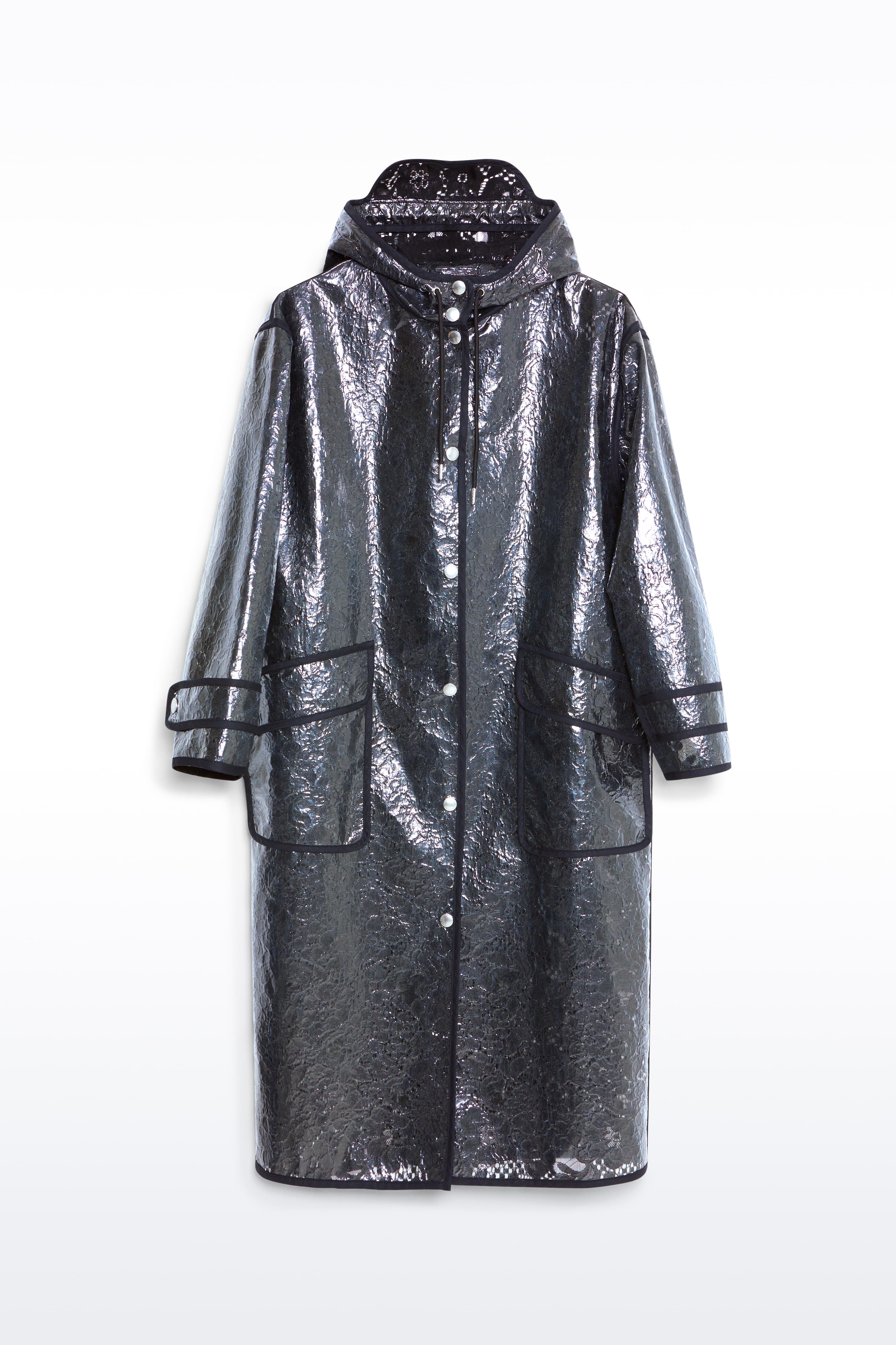 Packshot of the True Raincoat in Black, is a lightweight raincoat with a lace-patterned design.